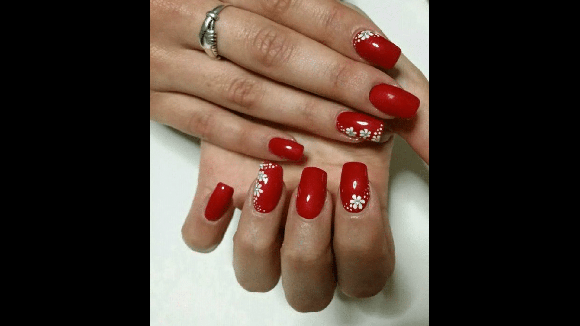 Deep red nails with floral nail art