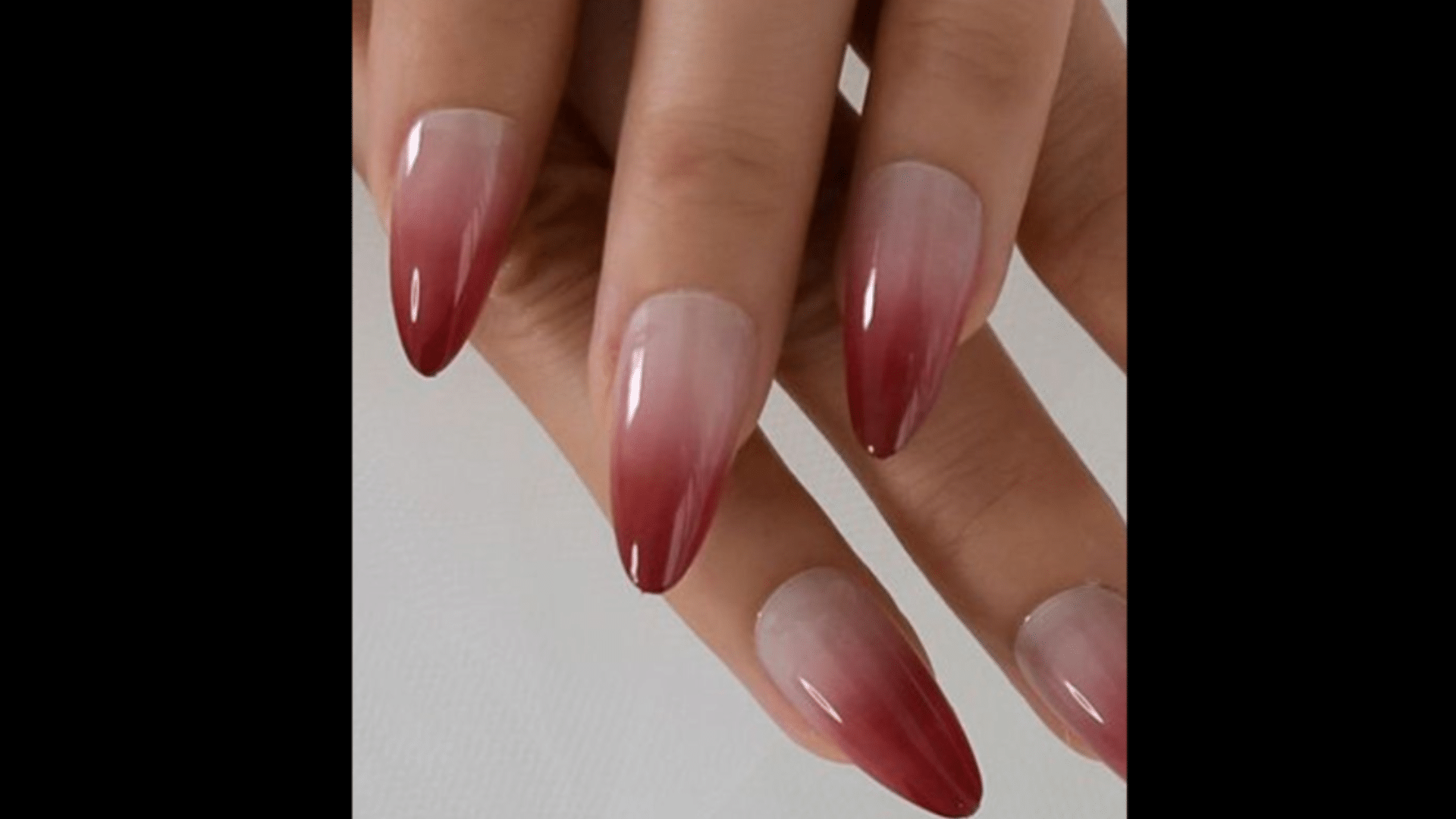 Ombre red nails fading from bright to deep red