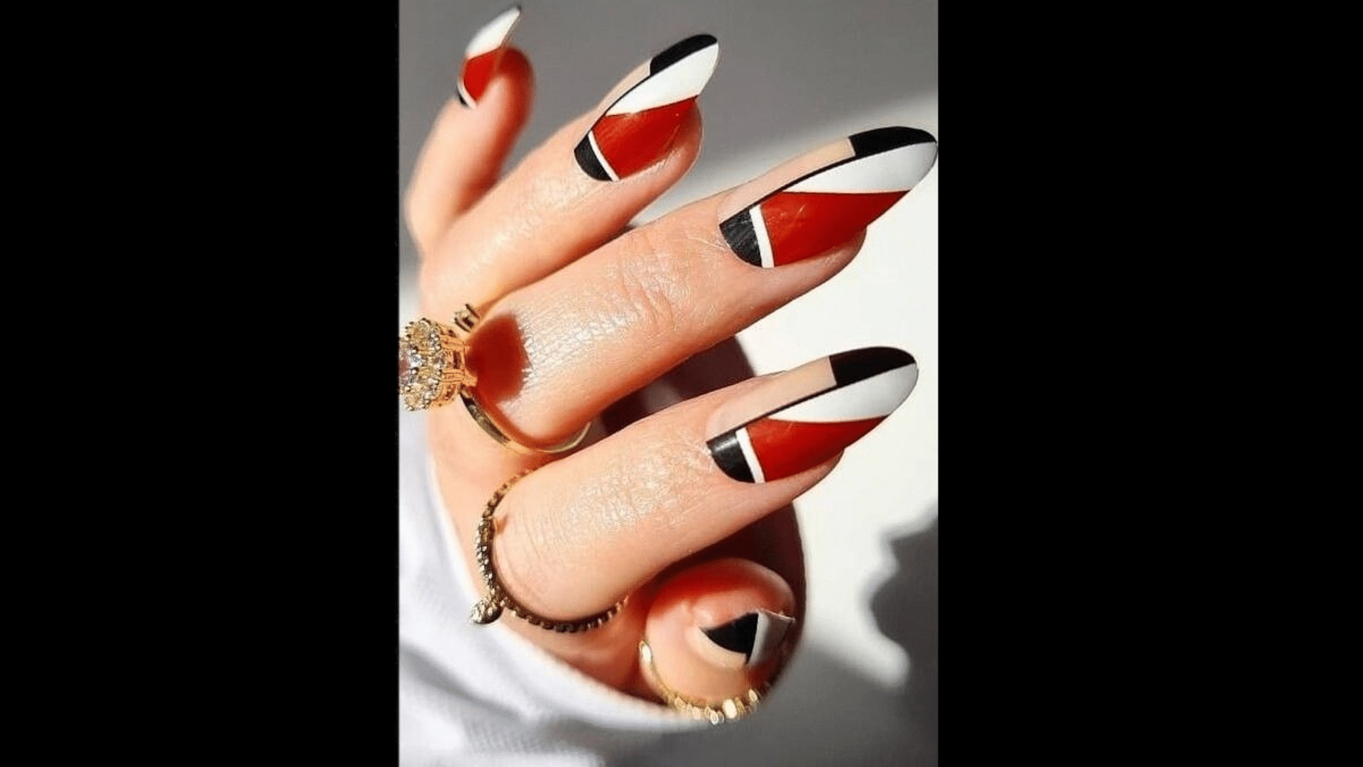 Red nails with geometric shapes in white