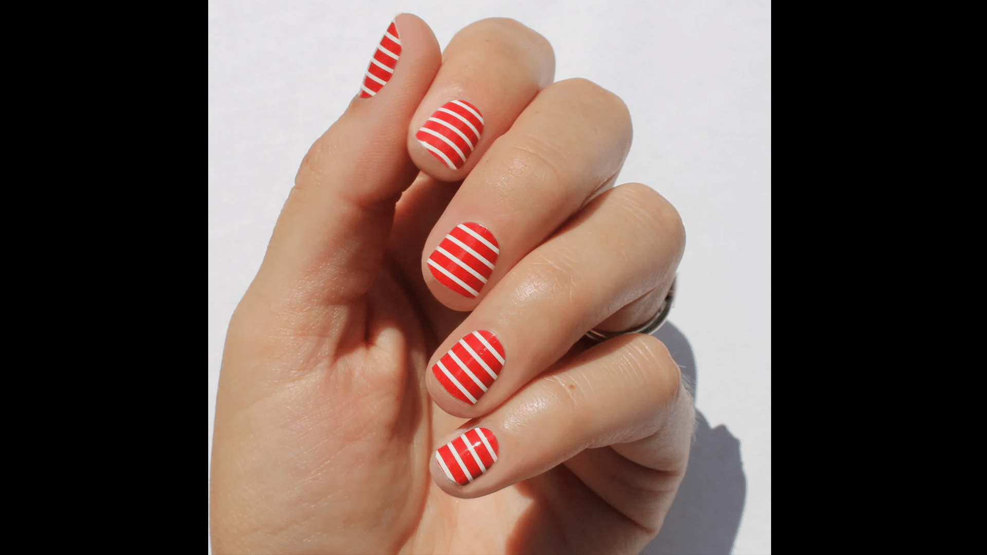 Red nails with white stripes