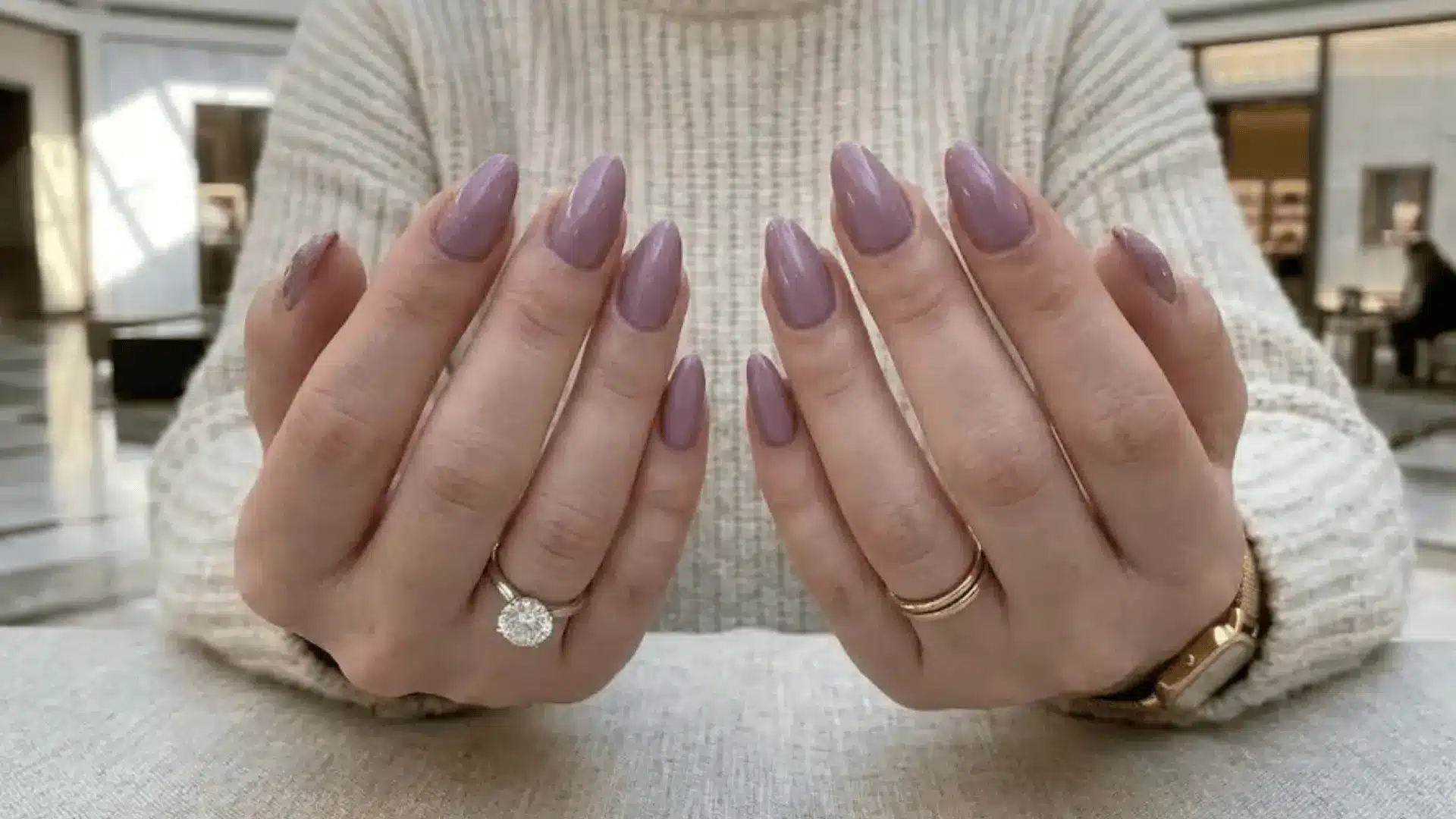 A simple mauve shade applied to almond shaped nails creates a clean manicure on oval shaped nails