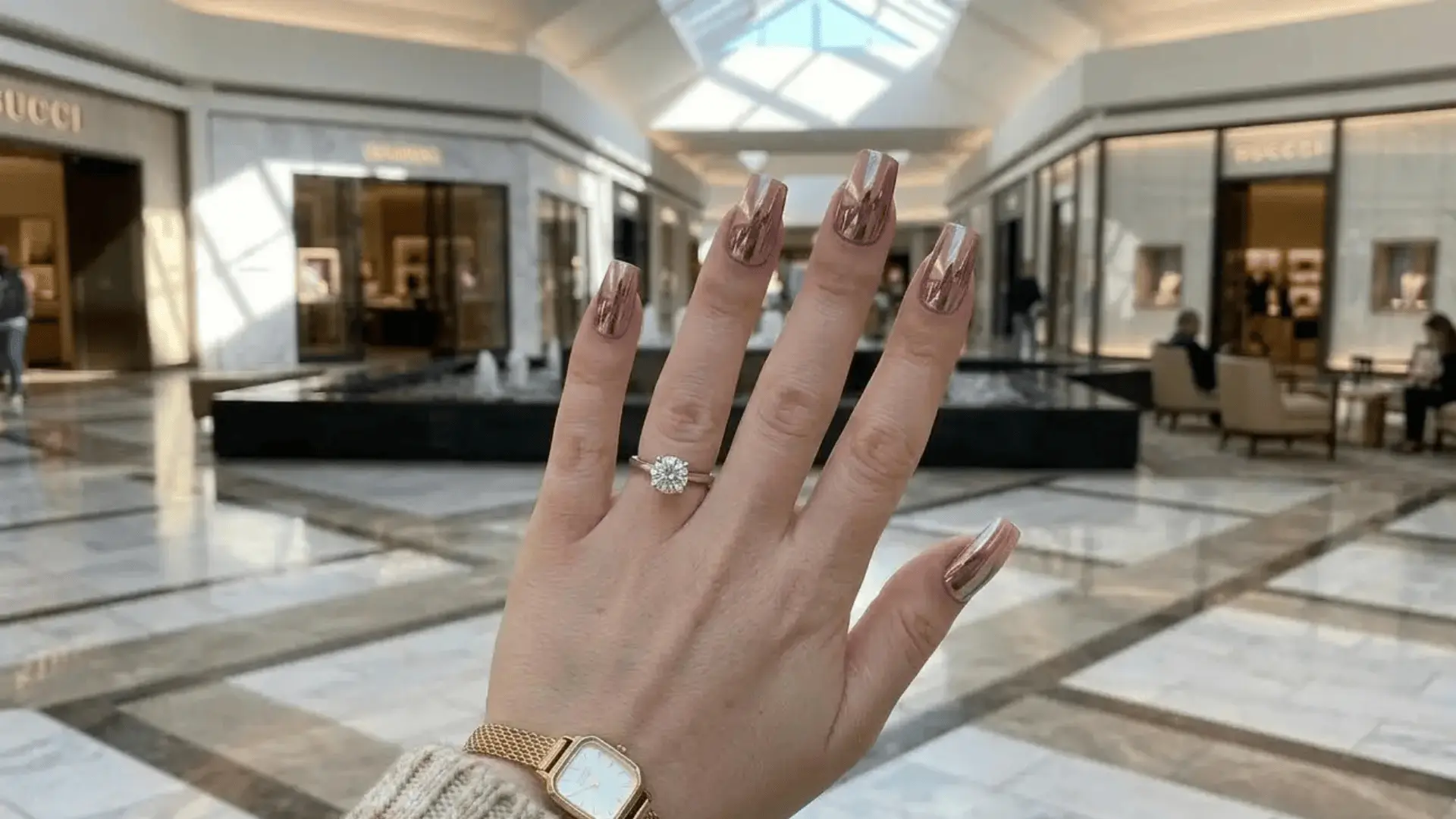 Chrome powder over mauve polish creates a reflective finish on a square shaped nails