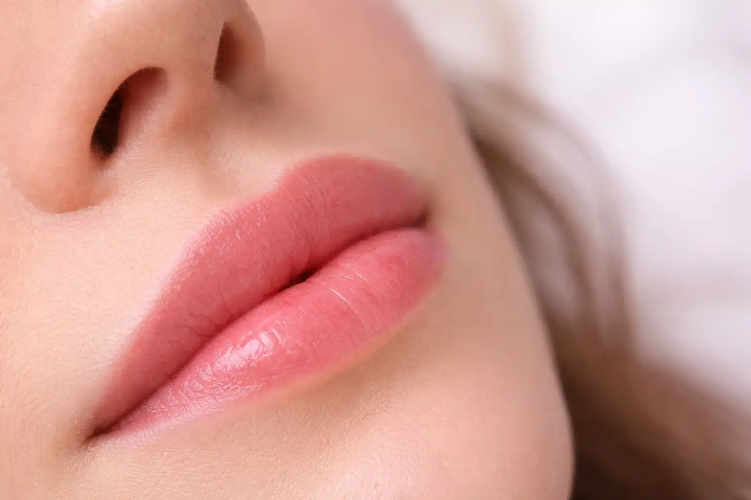 Close-up of healthy healed lip blush with smooth even tone and natural hydration, showing well-maintained results between sessions