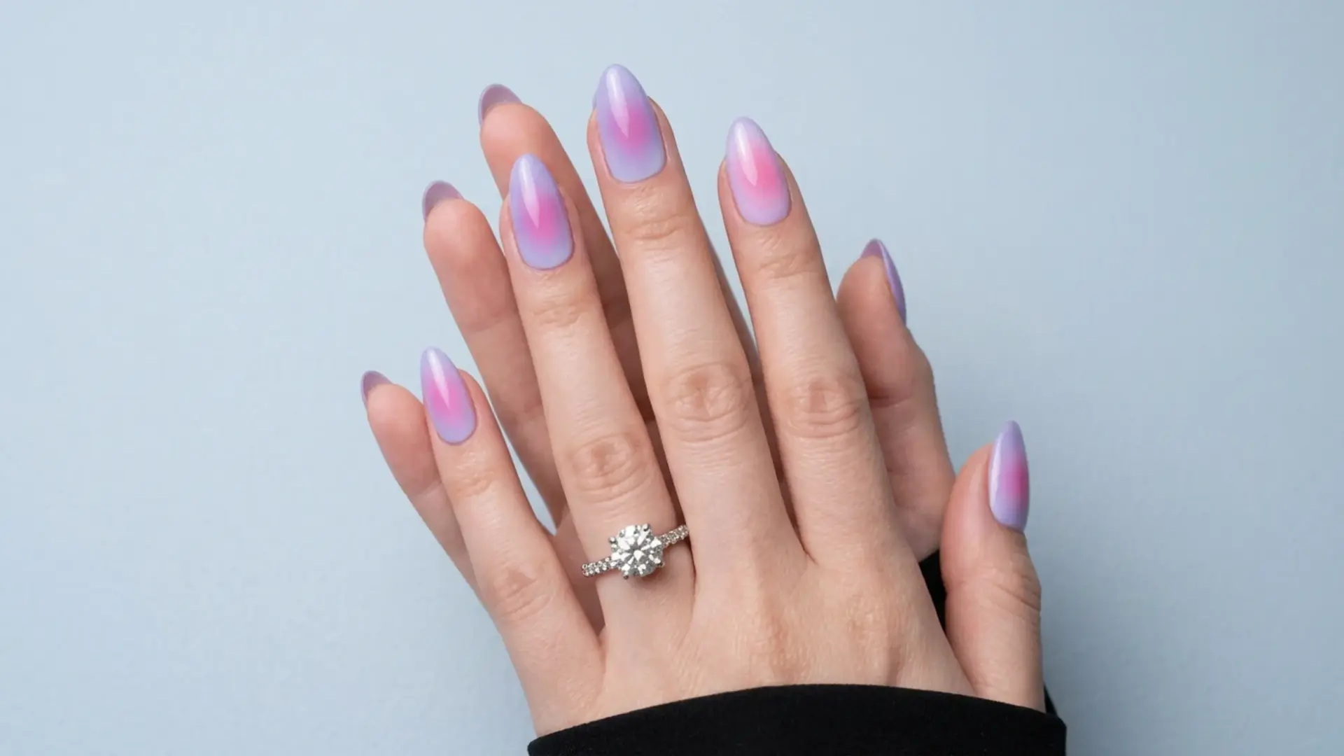 Purple and pink aura gradeint nails in almond shape with diamond ring displayed as soft pastel spring nails design