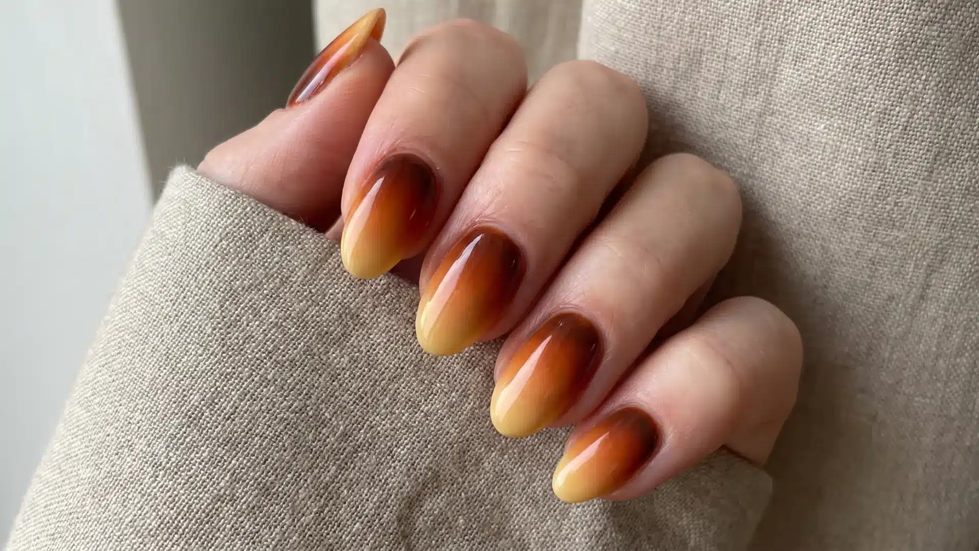Almond nails with ember gradient fading rust to amber to soft yellow