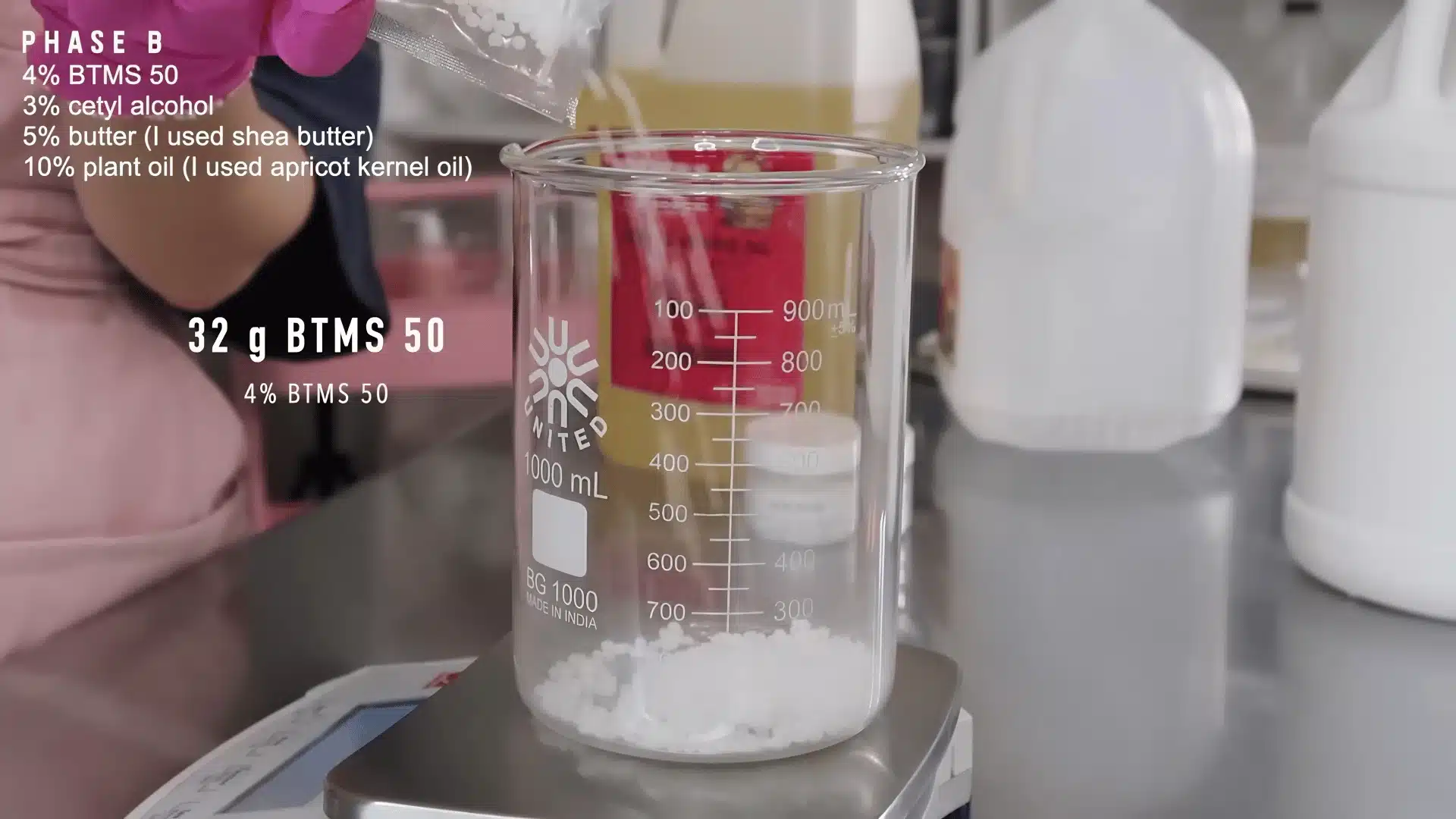 BTMS 50 emulsifier pellets added to a beaker for making homemade body lotion
