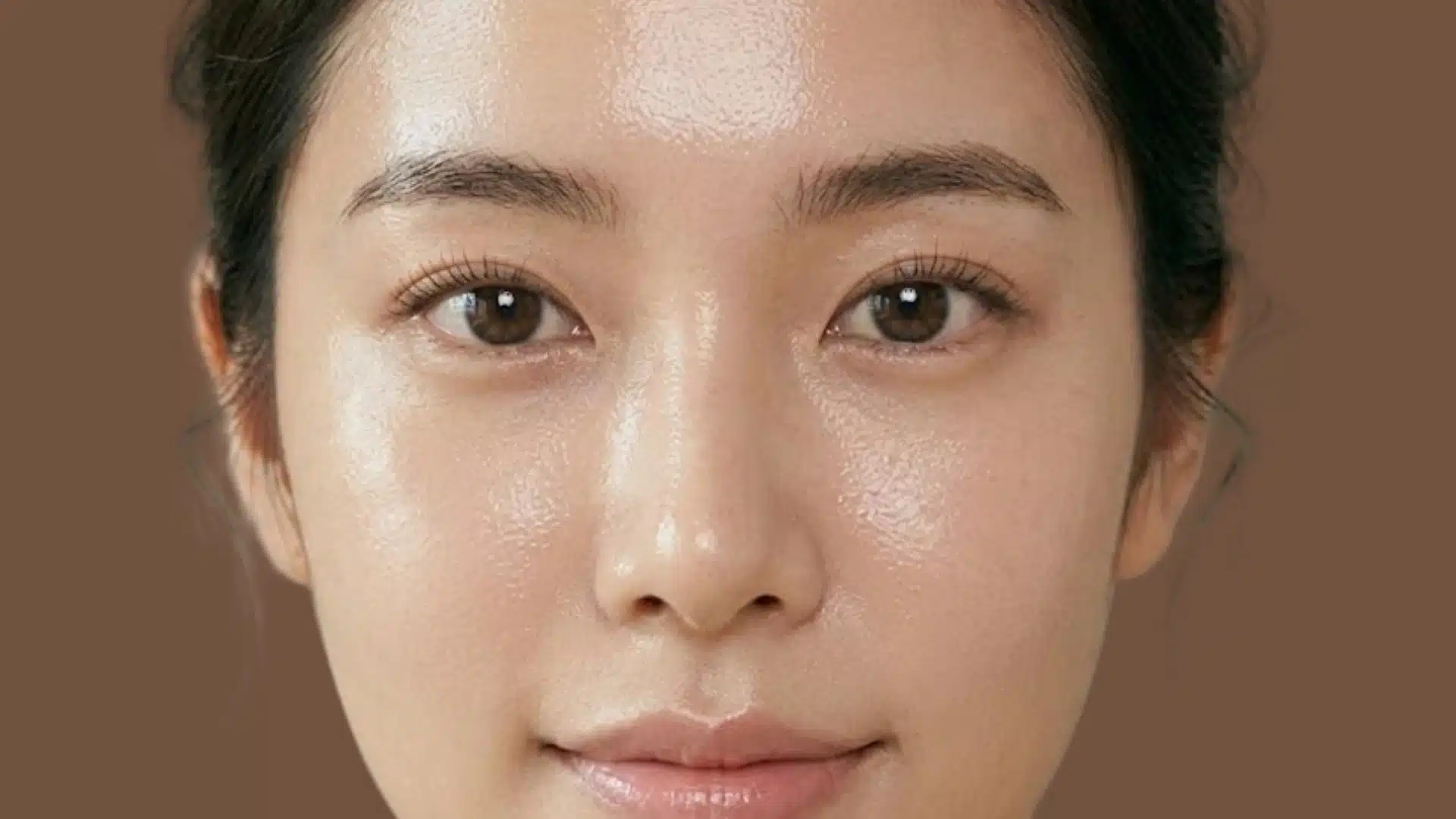 Close-up of glowing glass skin with dewy finish, smooth texture, and natural makeup highlighting Korean skincare standards
