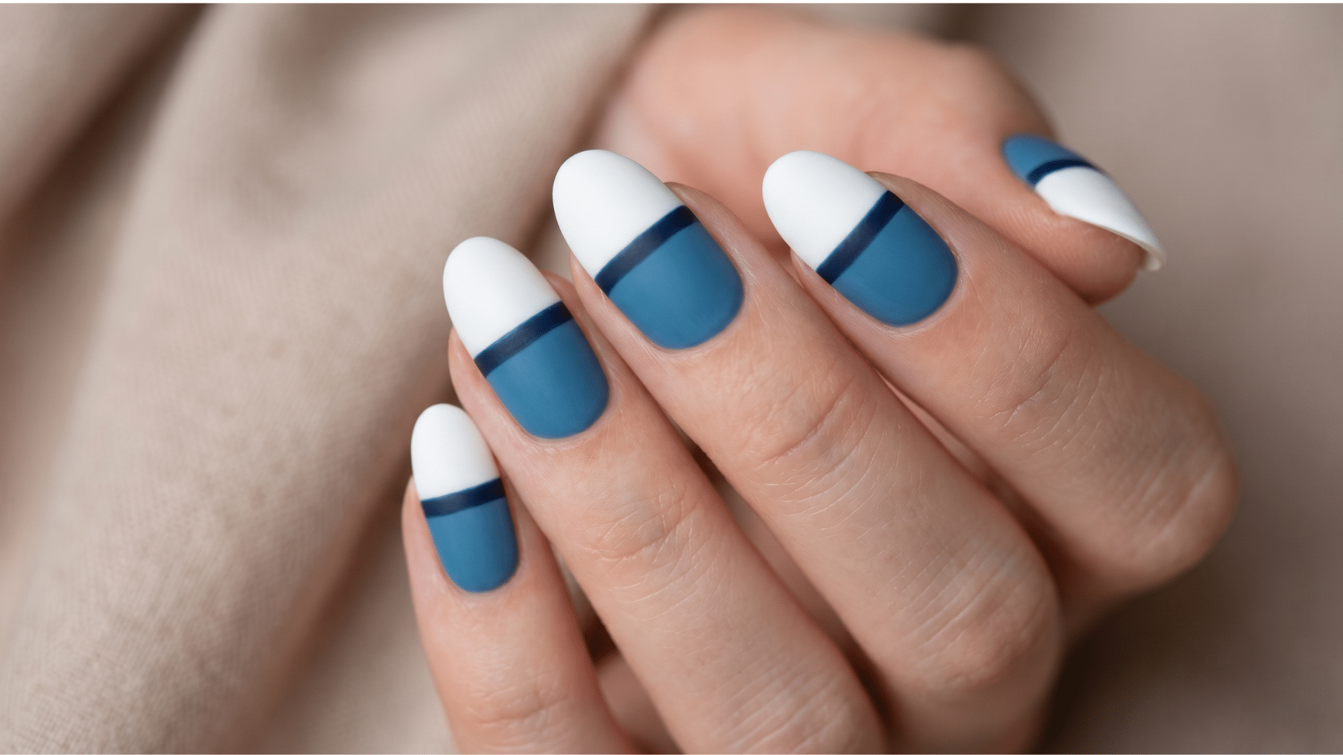 Close-up of horizon line nail art with white tips and blue bands