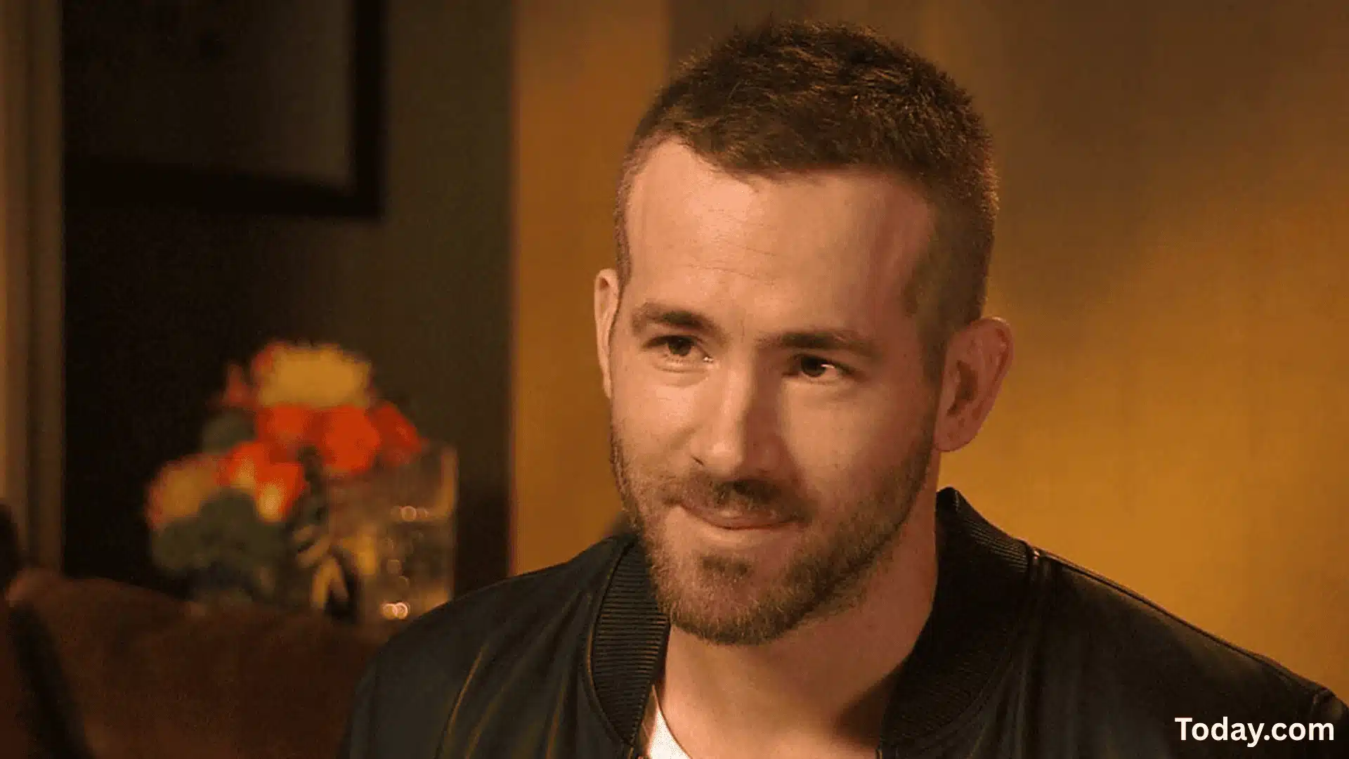 Close-up of Ryan Reynolds with textured crop buzz haircut, showing short, clean, and slightly rugged hairstyle look