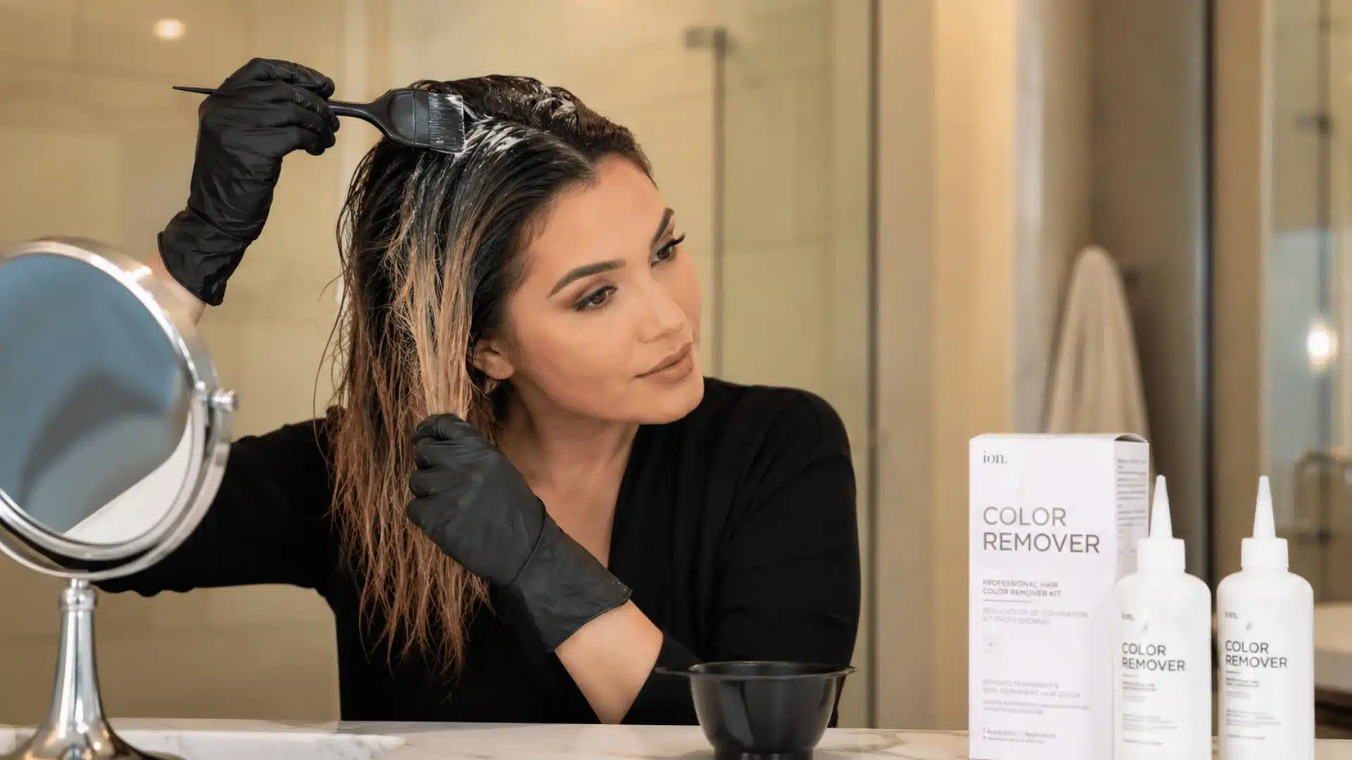 Commercial hair color remover being applied to dyed hair
