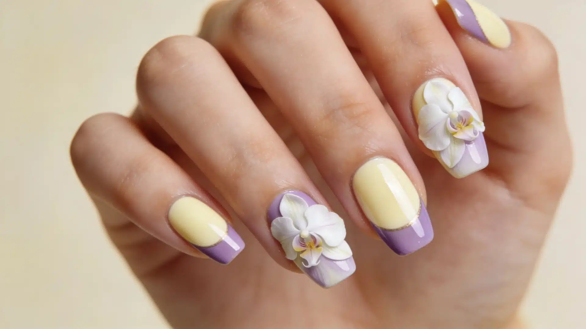 Cream and lavender nails with orchid floral accents and gold details