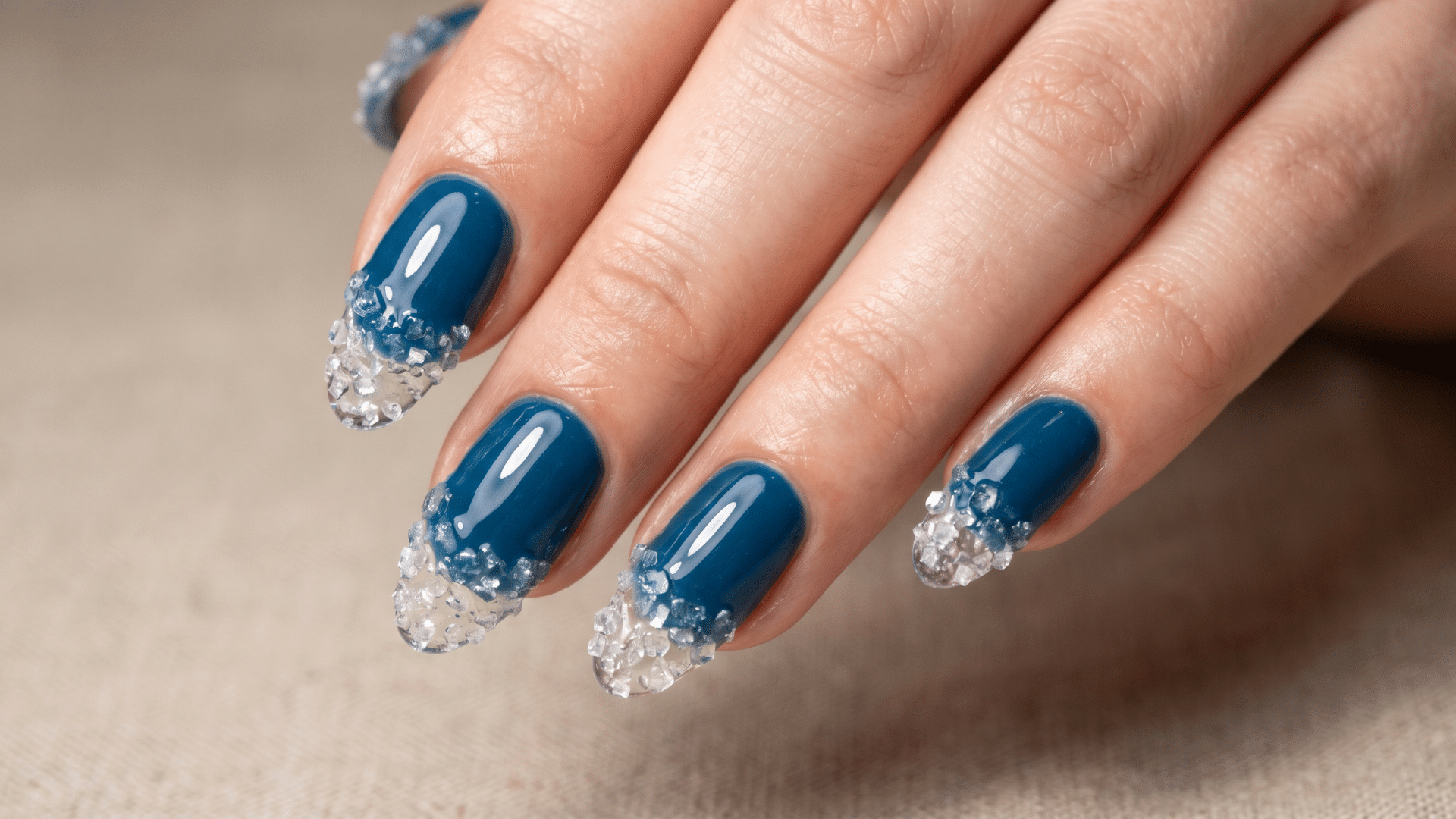 Deep blue nails with textured salt crystal tips creating a sea spray effect