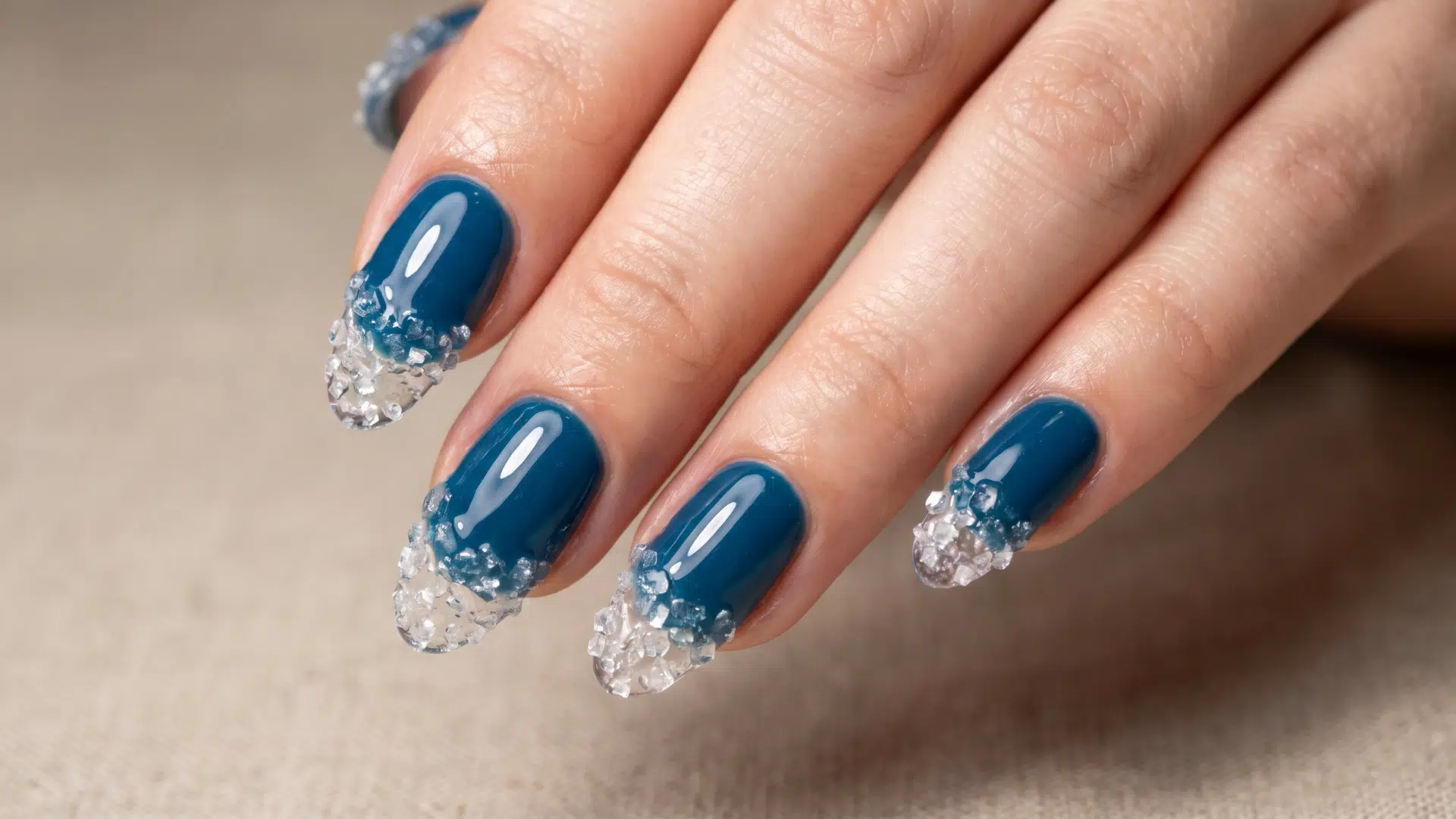 Deep blue nails with textured salt crystal tips creating a sea spray effect