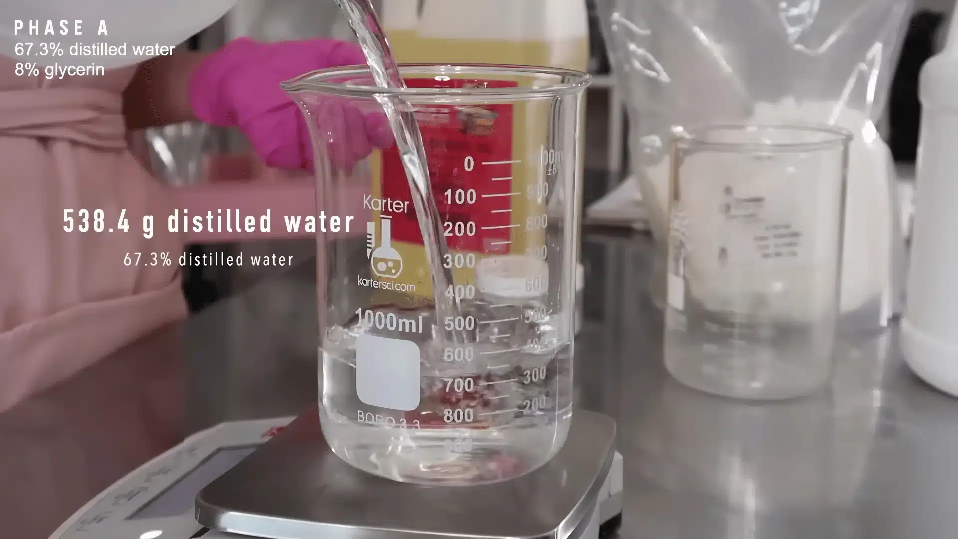 Distilled water being measured in a beaker on a digital scale for lotion recipe