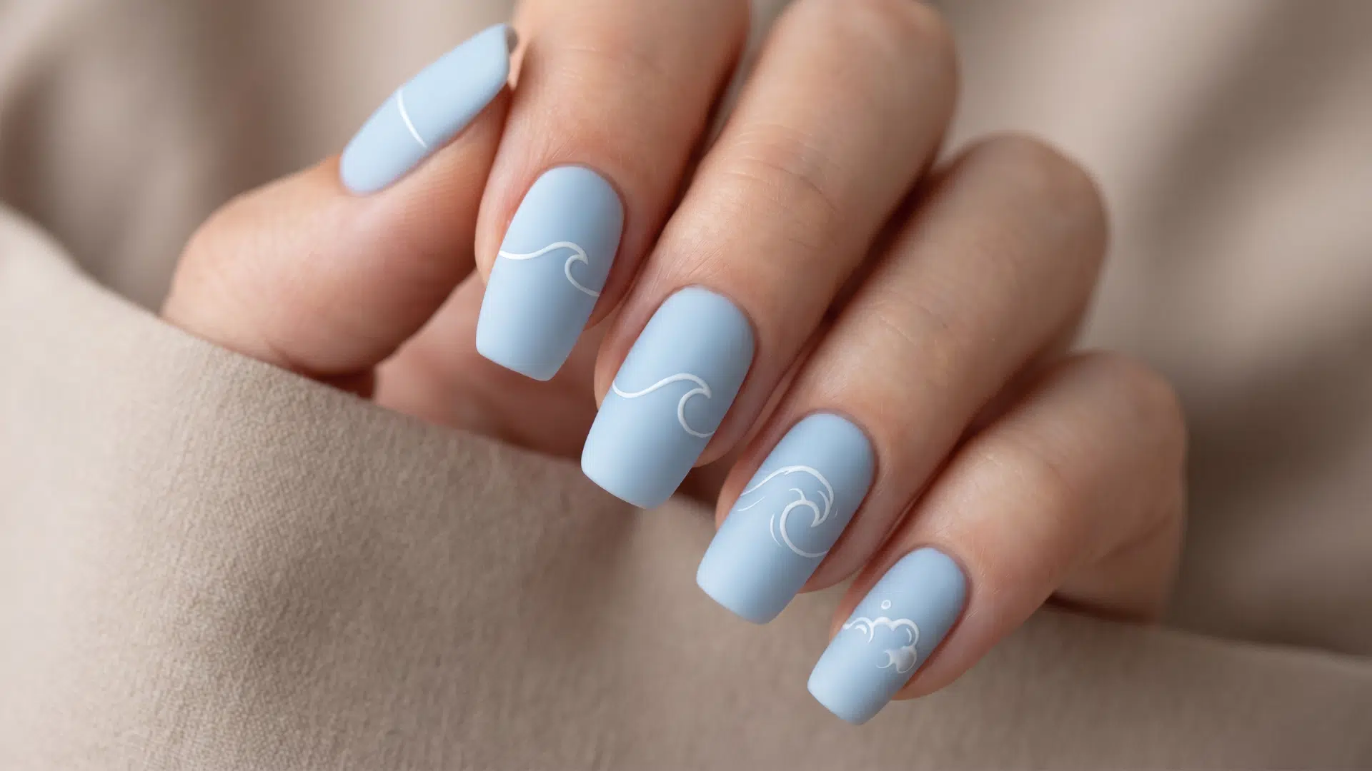 Matte pale blue nails with minimal white wave line art sequence design