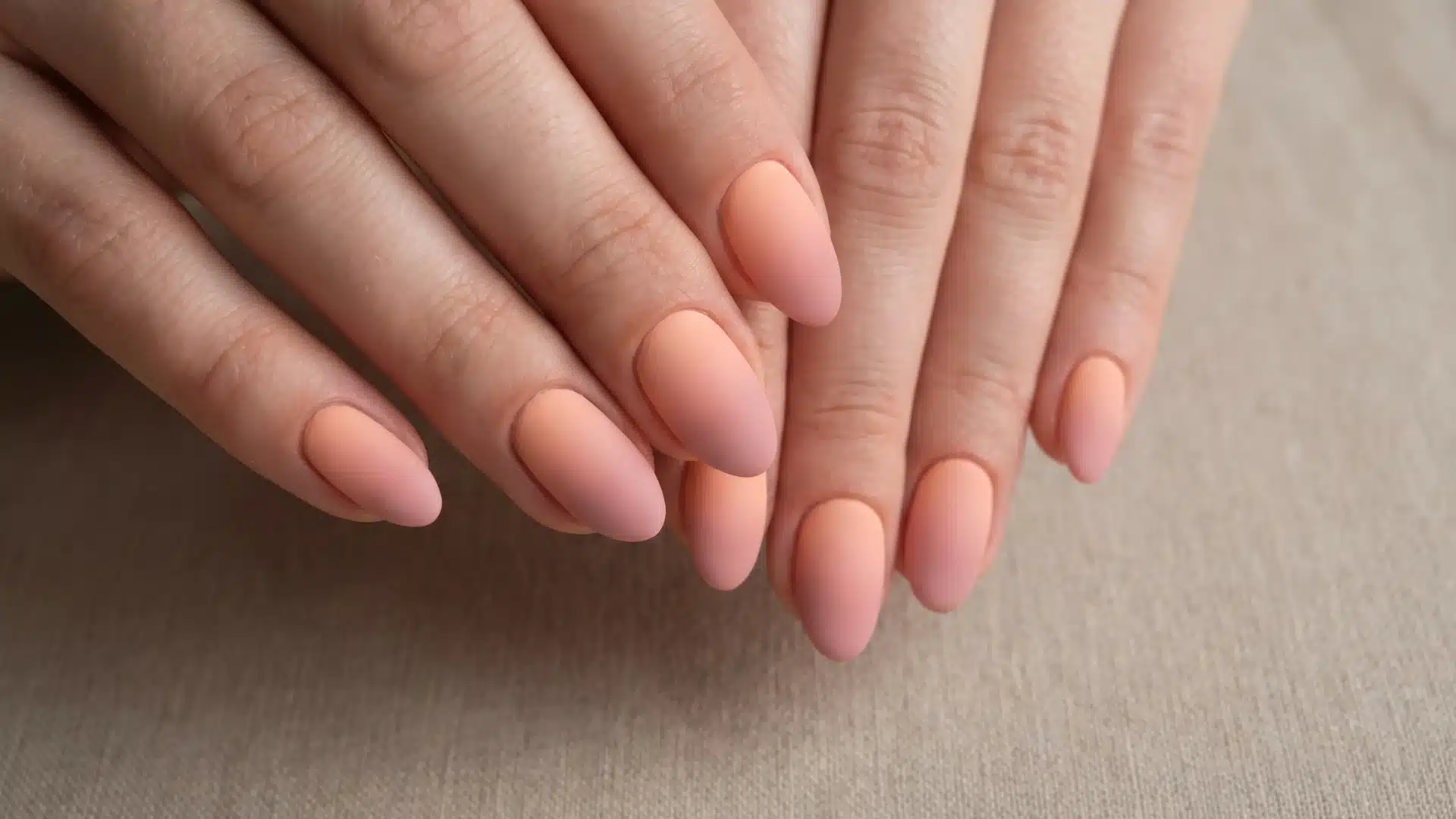 Matte peach to blush ombre nails with a soft, muted sunset gradient (1)