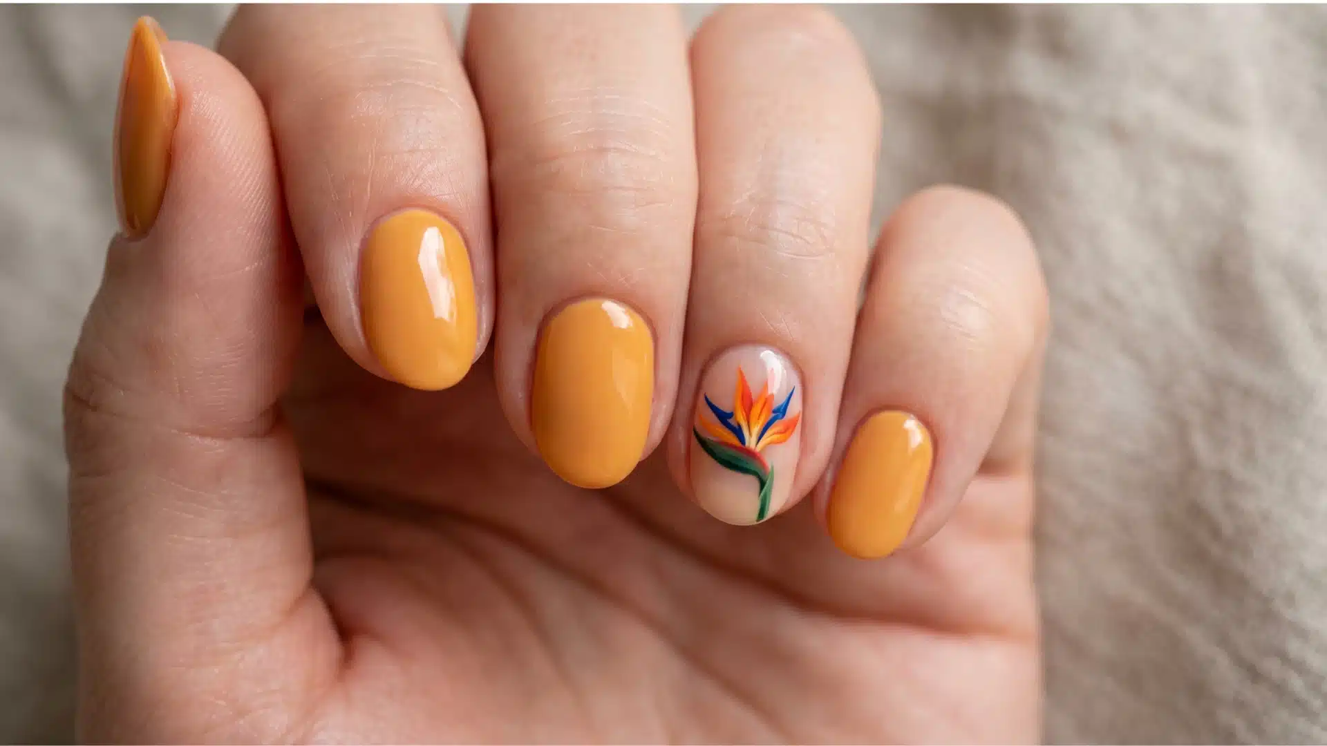Orange nails with bird of paradise flower accent on one nail