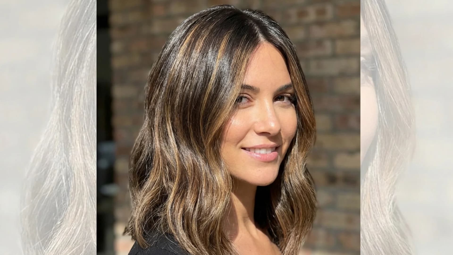 Portrait of a woman with professionally done highlights, lighter strands evenly distributed through her hair