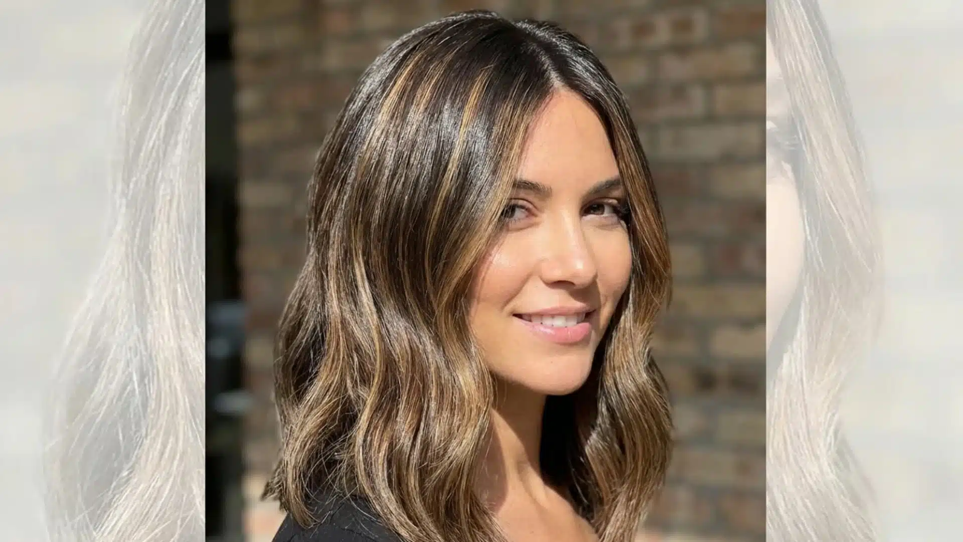 Portrait of a woman with professionally done highlights, lighter strands evenly distributed through her hair