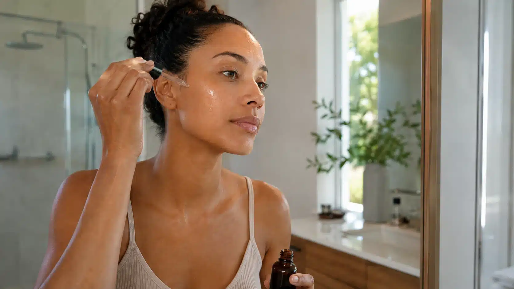Woman applying dark spot serum to face during morning skincare routine