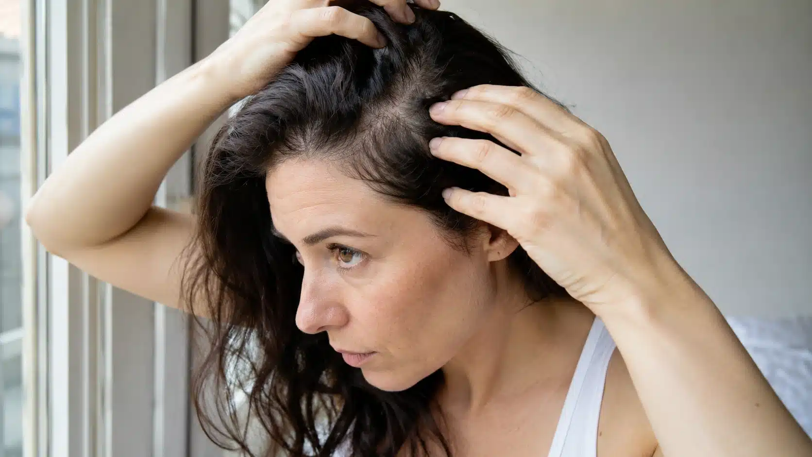 Woman checking hair veins in natural light to identify warm or cool skin undertone