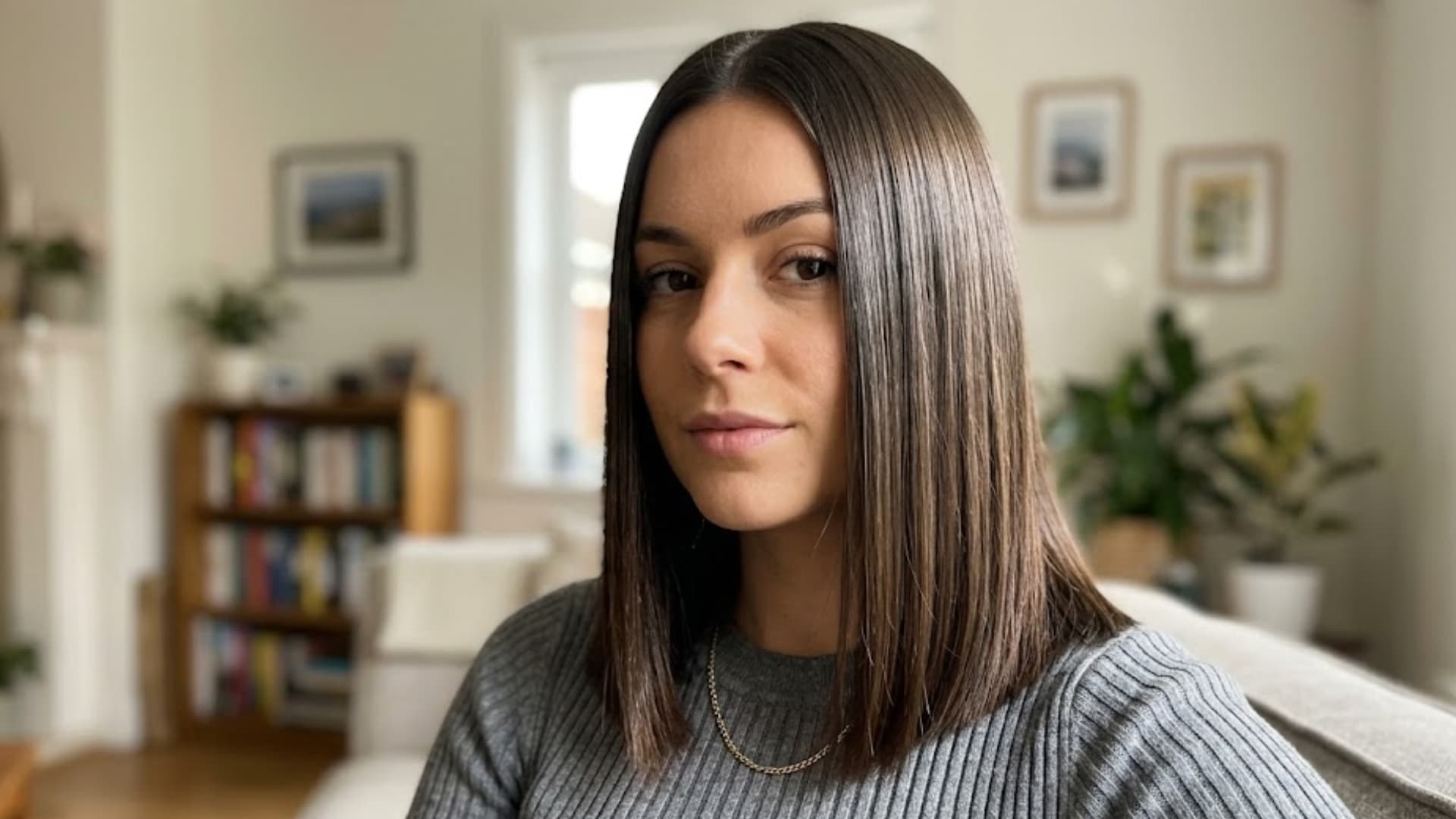 Woman with Straight Sleek Lob, layered dark brown hair styled in a smooth blowout