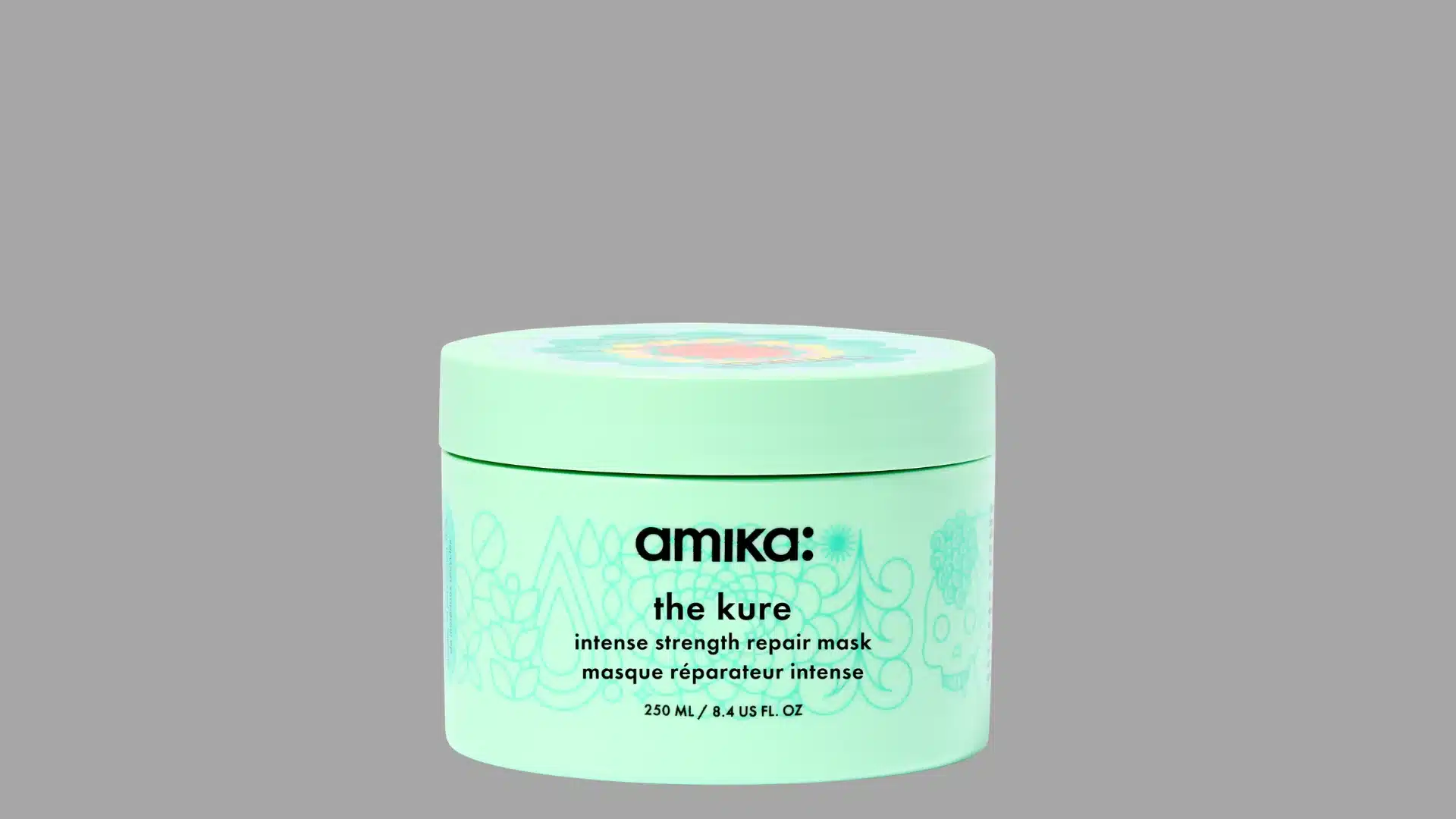 Amika The Kure intense strength repair hair mask in a light green jar against a gray background