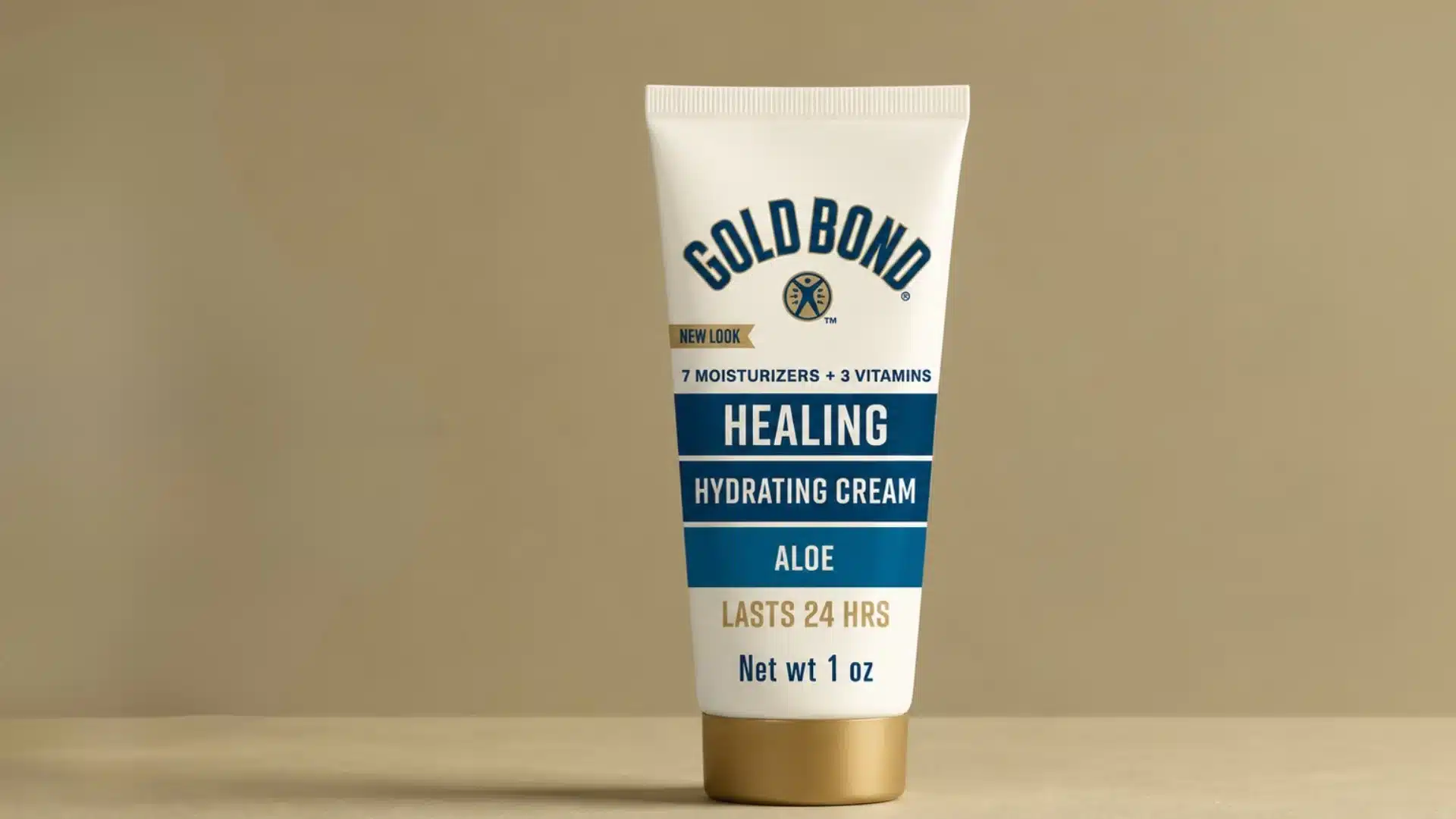 A tube of Gold Bond Healing Hydrating Cream standing upright against a plain, light brown background