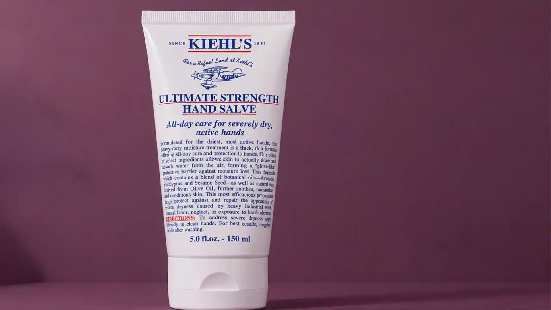 A tube of Kiehl's Ultimate Strength Hand Salve standing upright against a solid purple background