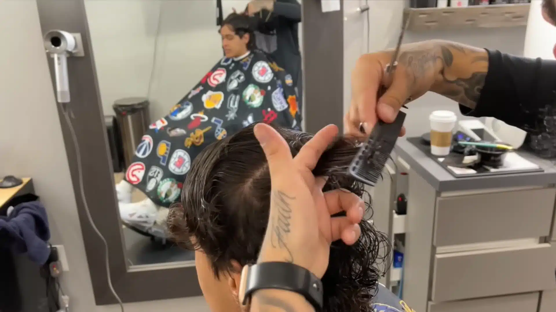 Barber evens the front fringe with scissors and cleans the back for a neat layered haircut finish