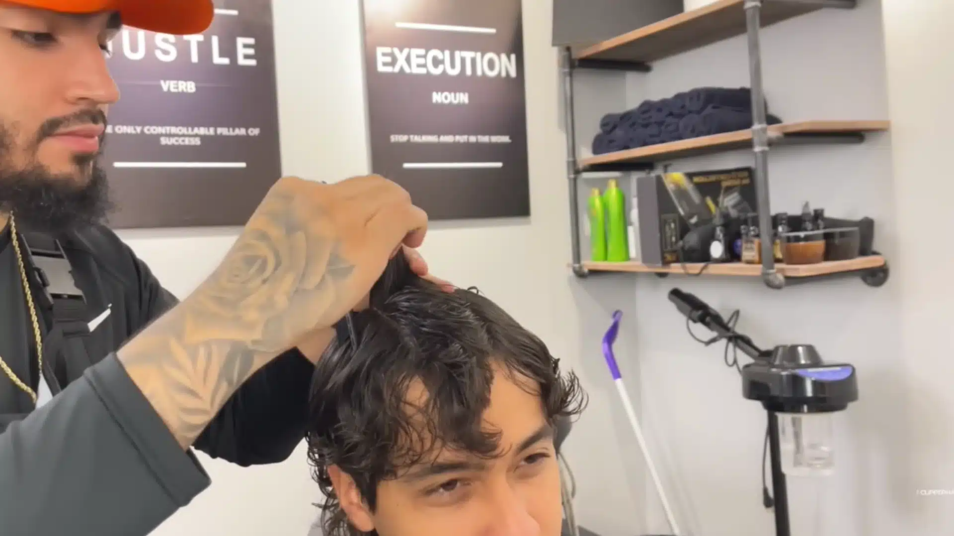 Barber matches right and left top sections to the middle guide for balanced layers on damp hair cut