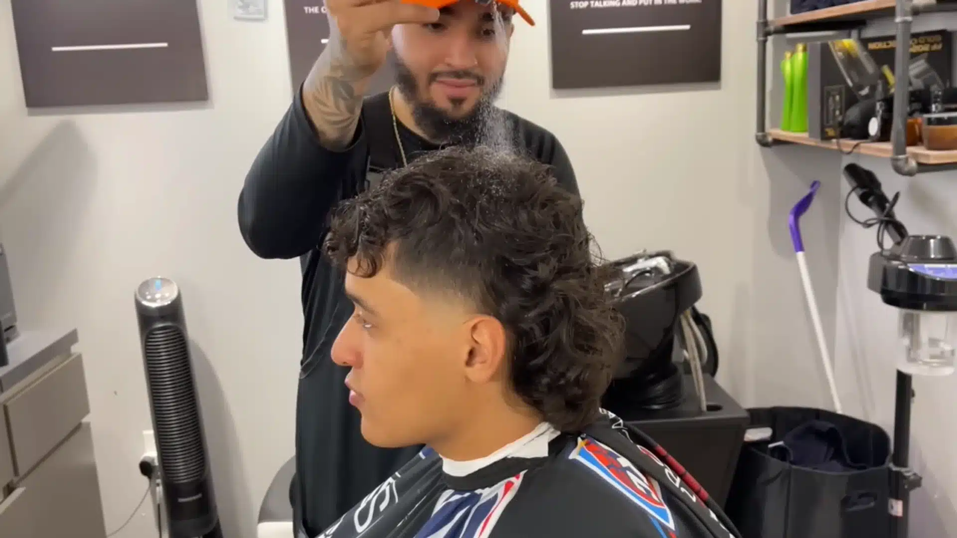 Barber softens, lines up, and styles a curly mullet with a clean taper fade and natural texture