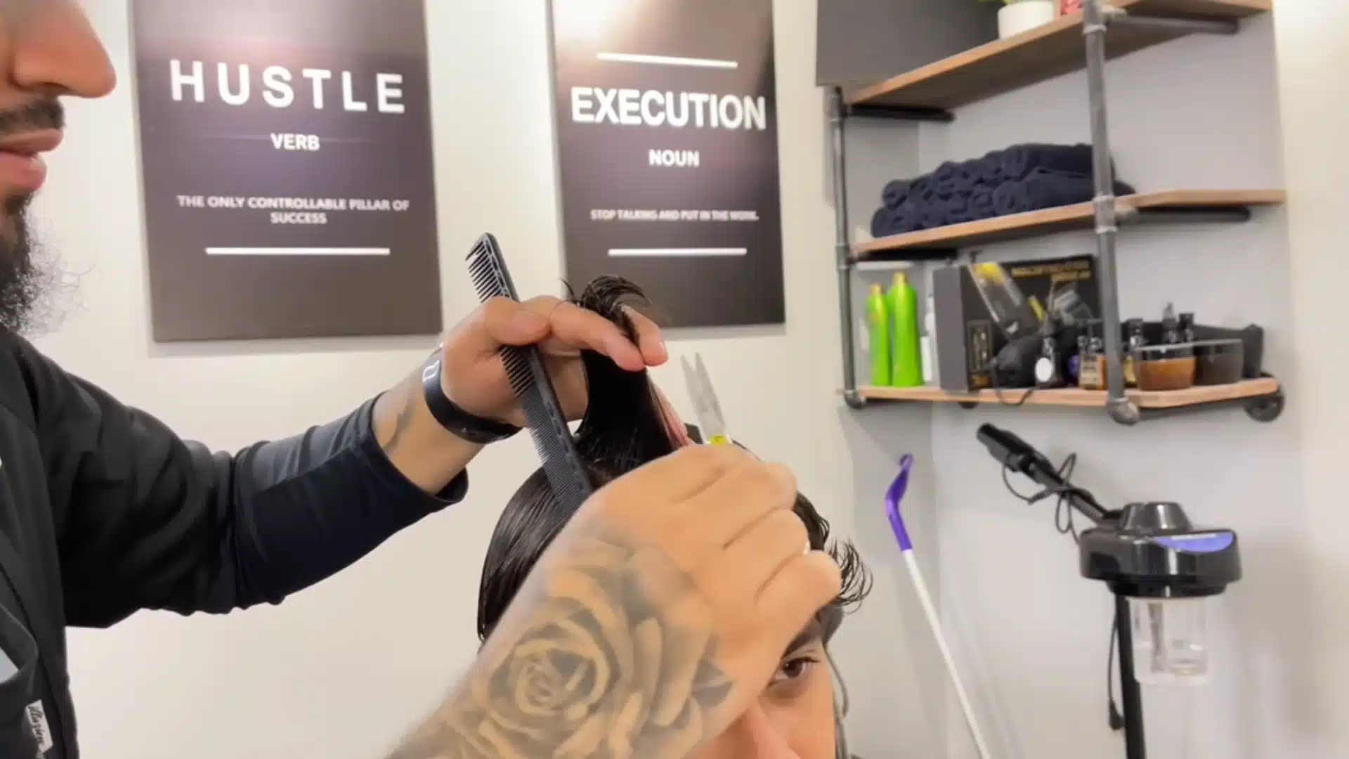 Barber trims the middle guide on top with scissors and comb to shape an even layered haircut cleanly