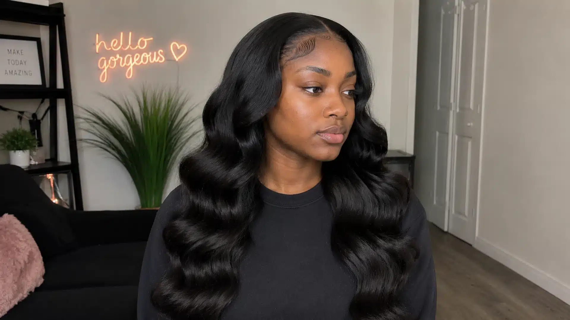 Body wave sew-in with side part, defined waves, sleek black finish, and shaped baby hairs