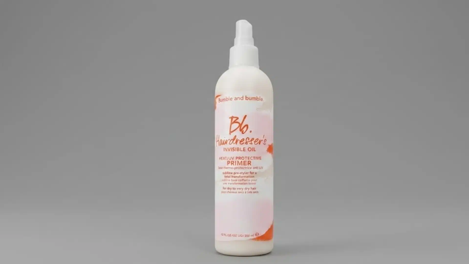 Bumble and Bumble Invisible Oil heat primer bottle on a gray background