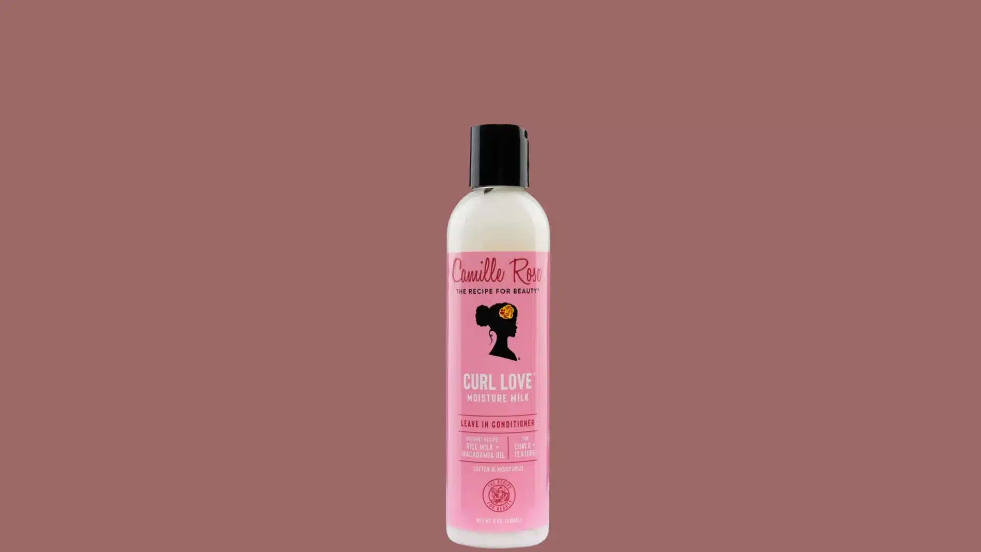 Camille Rose Curl Love Moisture Milk bottle with a pink label against a dusty rose background