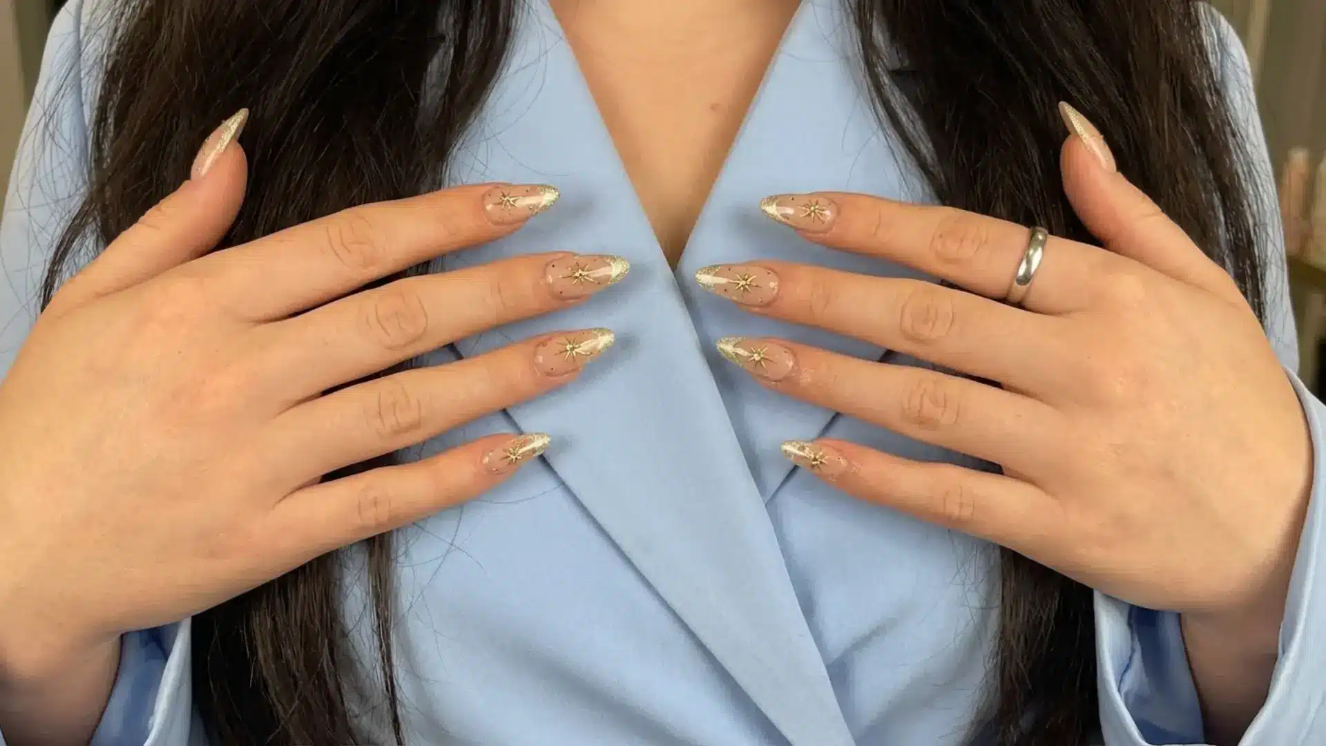 Champagne cat eye nails with gold star accent manicure on almond nails shown as elegant bridemaids nail ideas