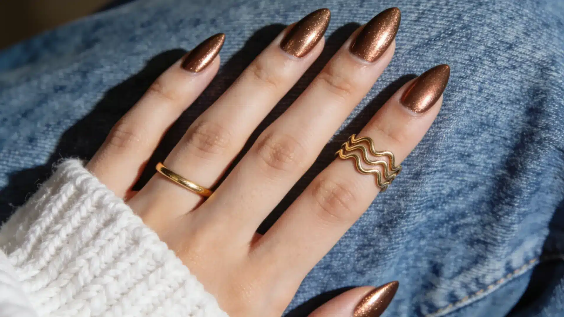 Chocolate glazed donut almond nails with bronze chrome shine and gold rings