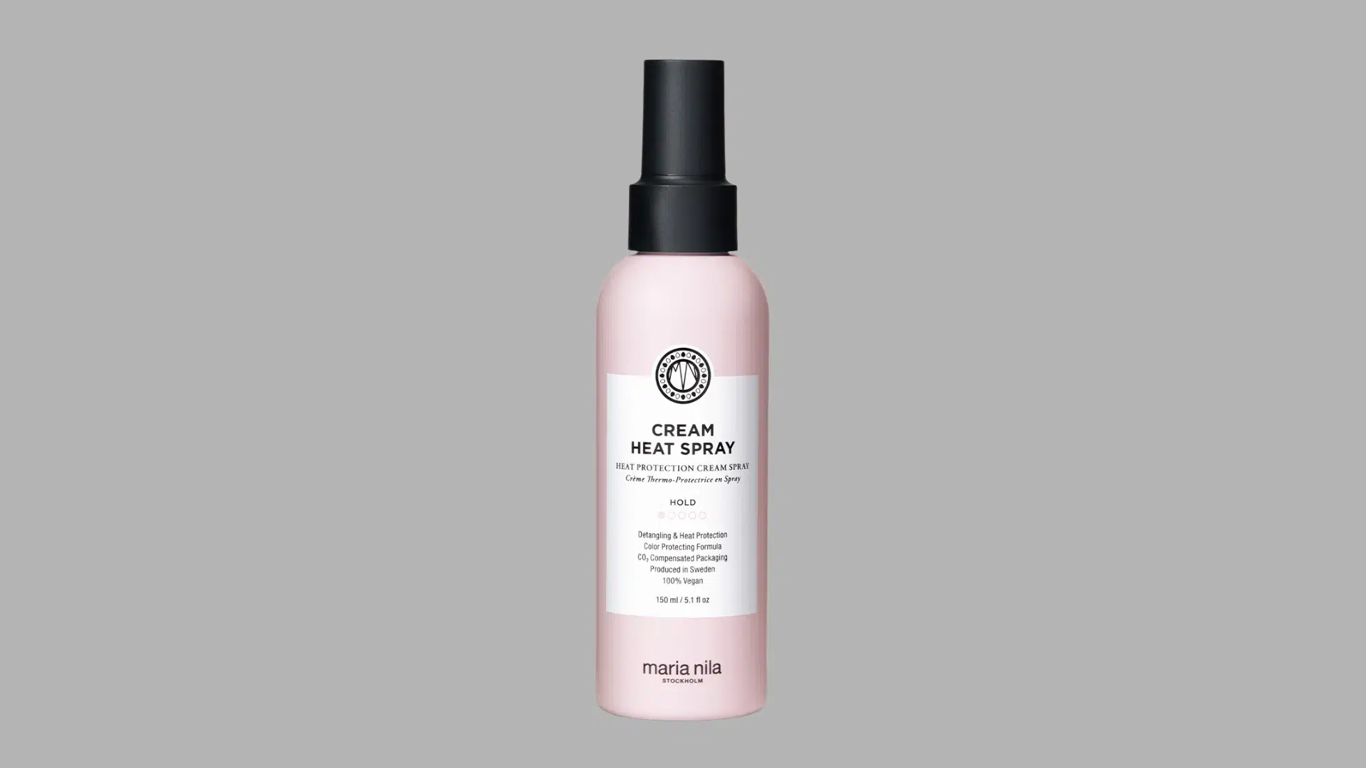 Cream Heat Spray bottle with black cap on a minimalist beige surface and soft neutral background