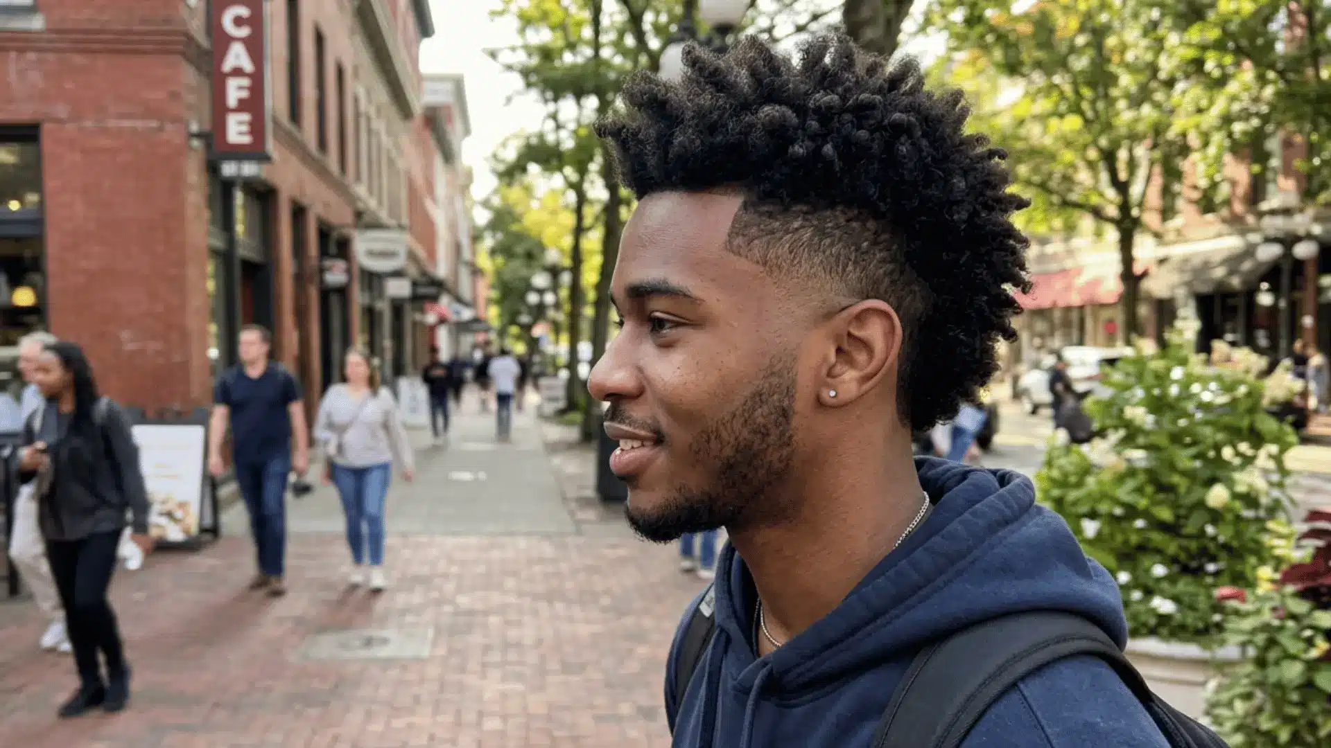 Curly burst fade mohawk on young man
