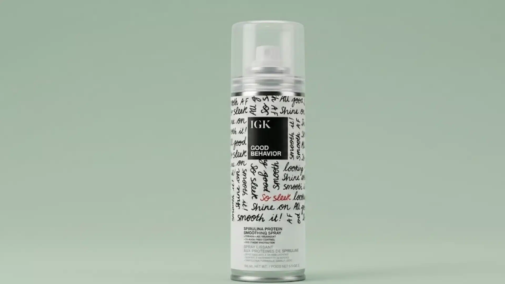 IGK Good Behavior smoothing spray can on a soft green background with clean studio lighting
