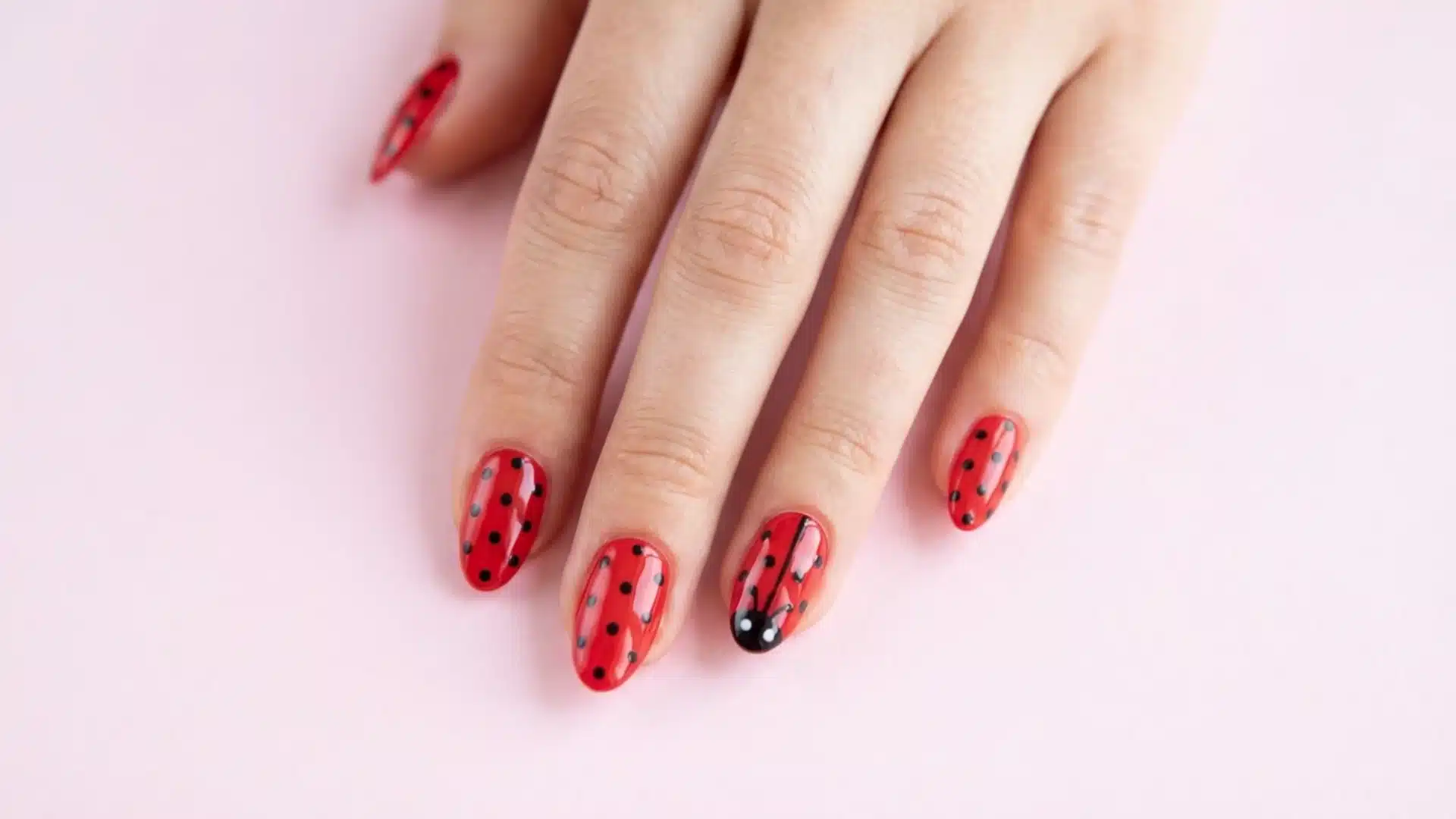Ladybug Dot nails featuring glossy red polish with black polka dots and accent nail design