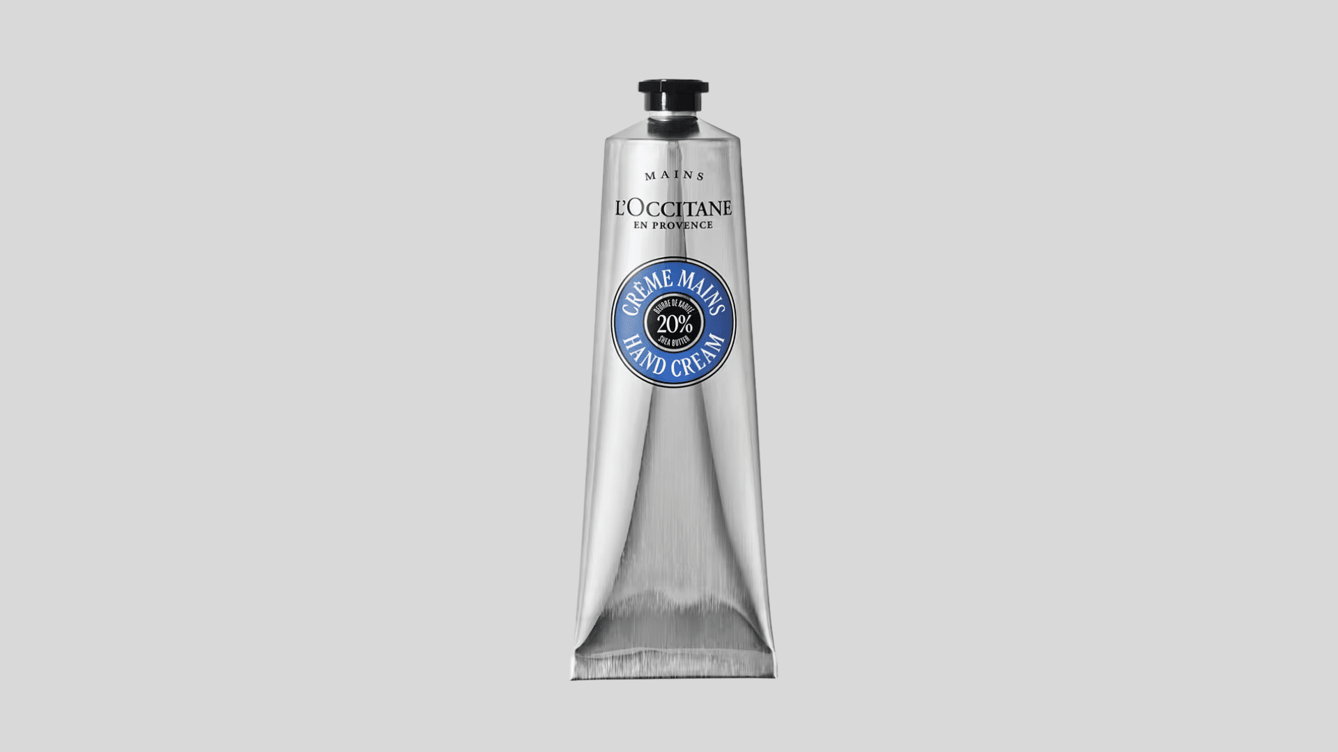 L'Occitane Shea Butter Hand Cream tube with silver packaging displayed on a light gray background showcasing the product design