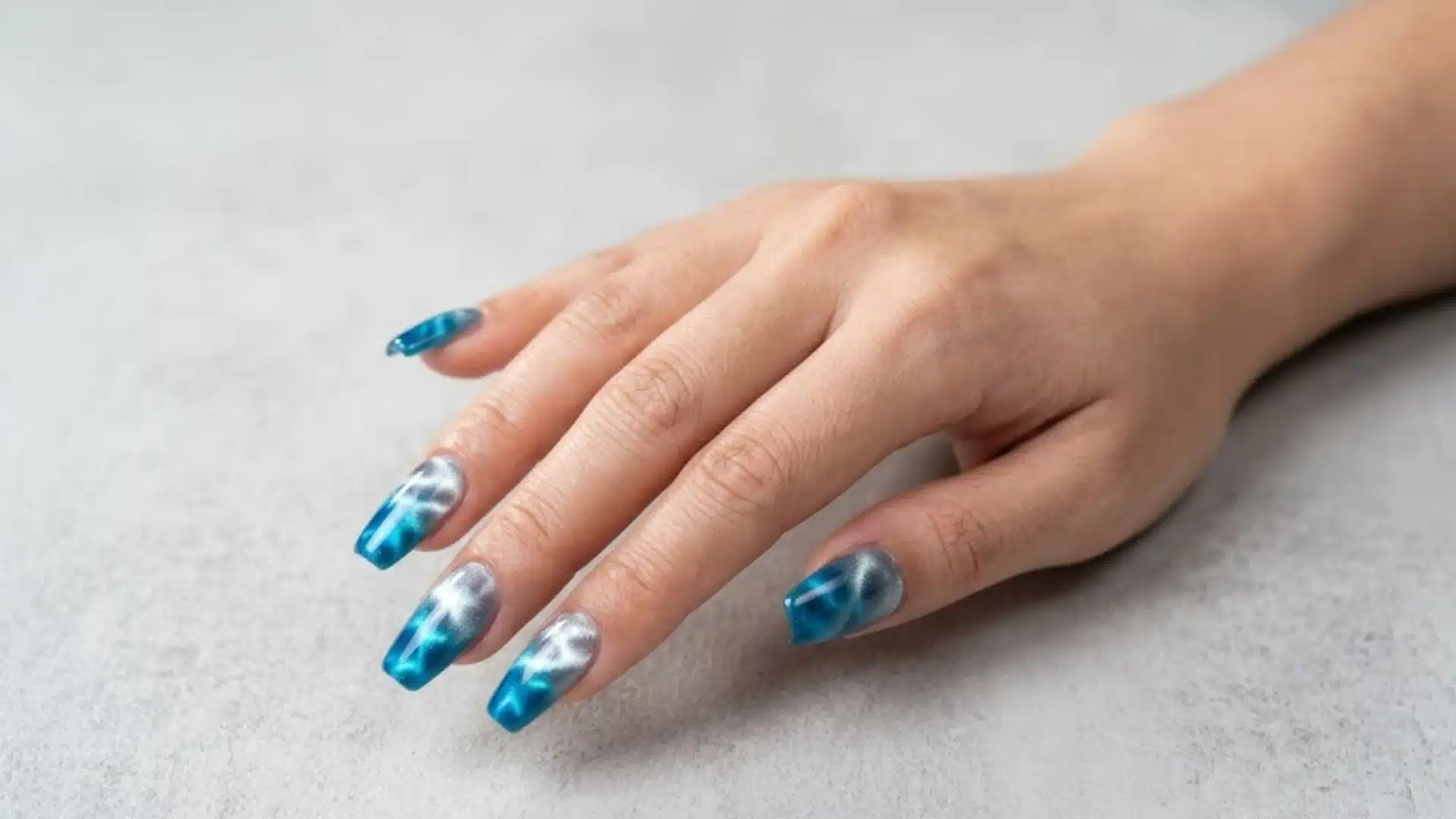 Magnetic Wave Nails in blue ombre chrome with soft cloud effect, glossy finish, modern gradient nail design