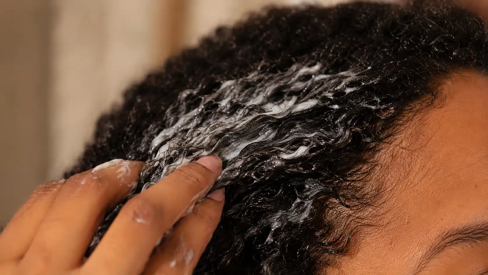 Oily hair being moisturized during wash routine