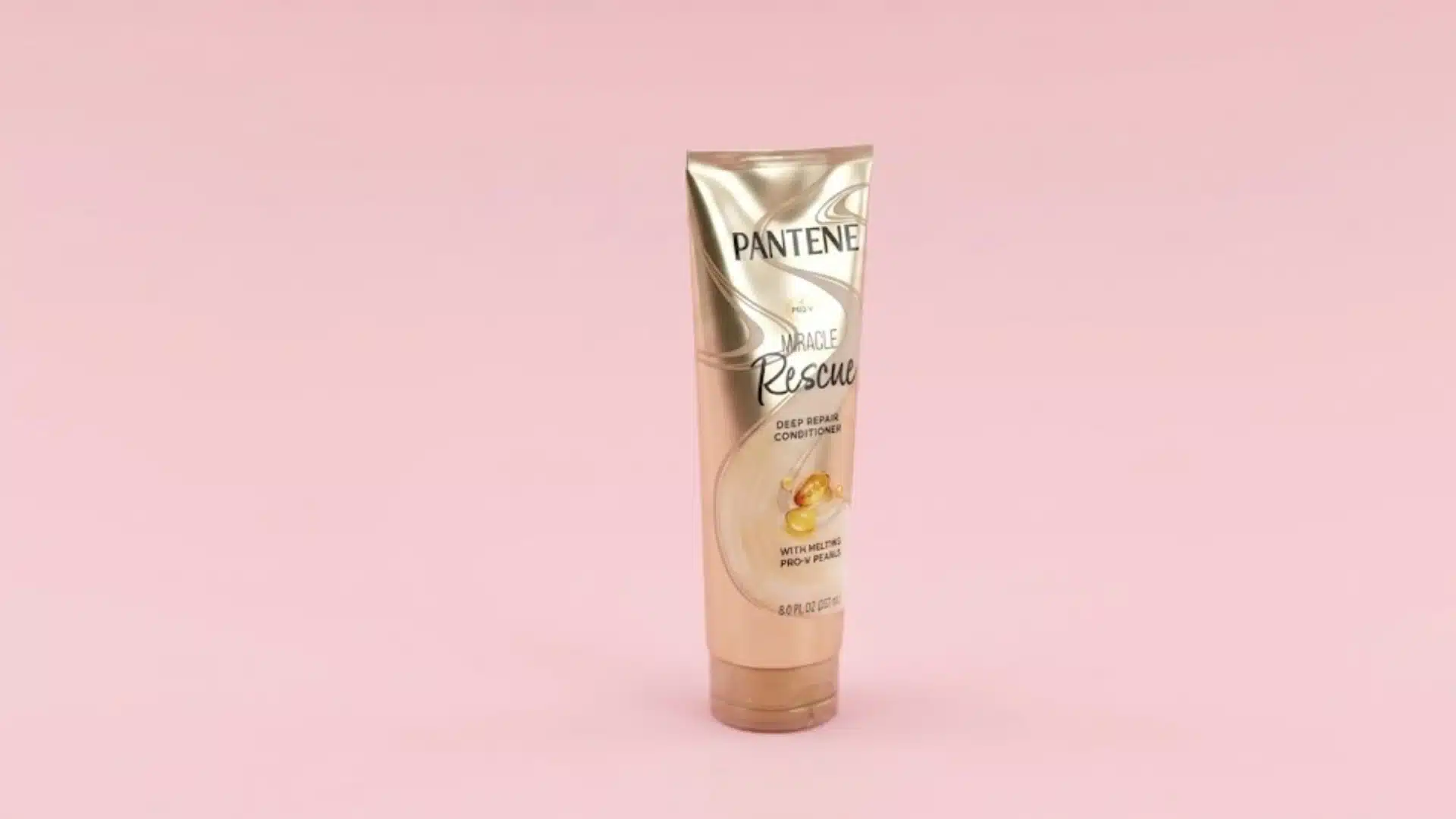 Pantene Miracle Rescue Deep Repair Conditioner tube on a pink background for damaged and dry hair treatment product