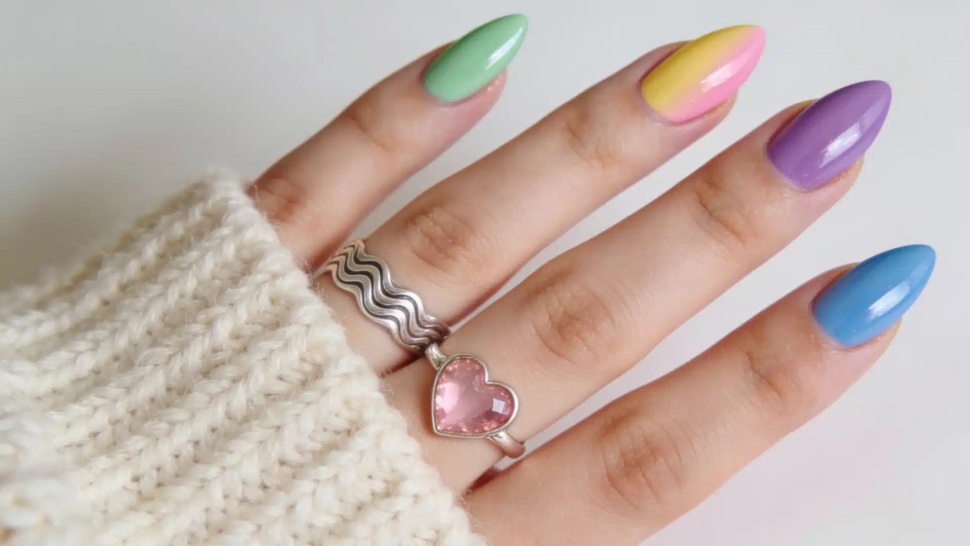 Pastel chrome glazed almond nails in green, yellow, pink, purple, and blue