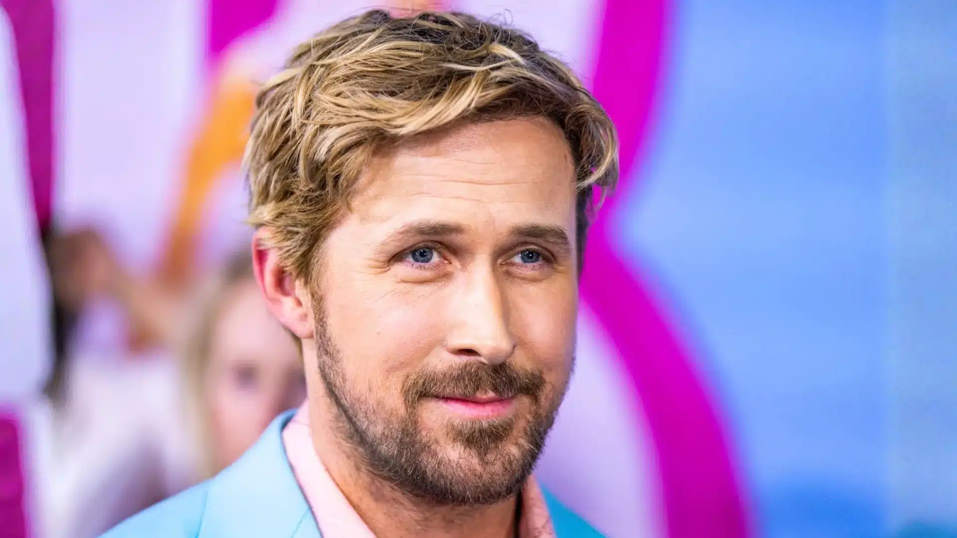 Ryan Gosling with soft cool undertones and light hair against pastel background, illustrating light summer palette with gentle contrast