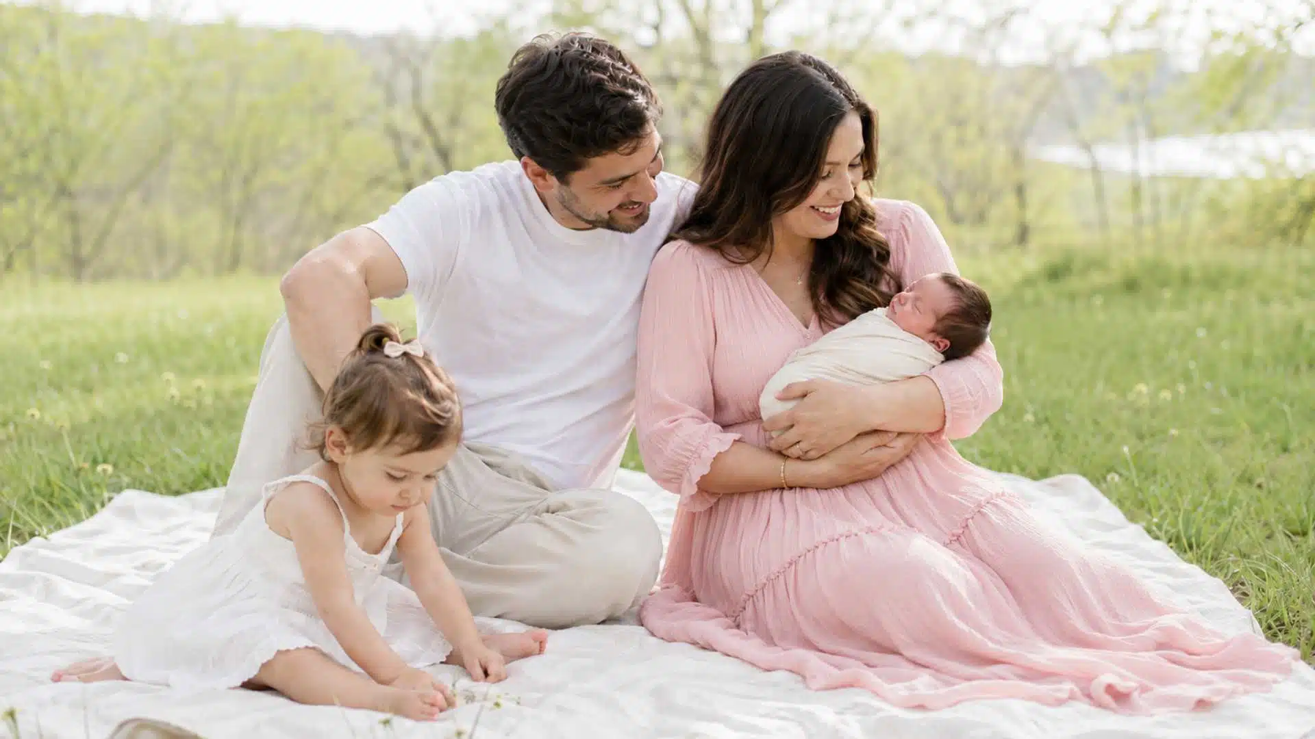 Spring outdoor newborn family photo session in blush, cream, and white coordinated outfits