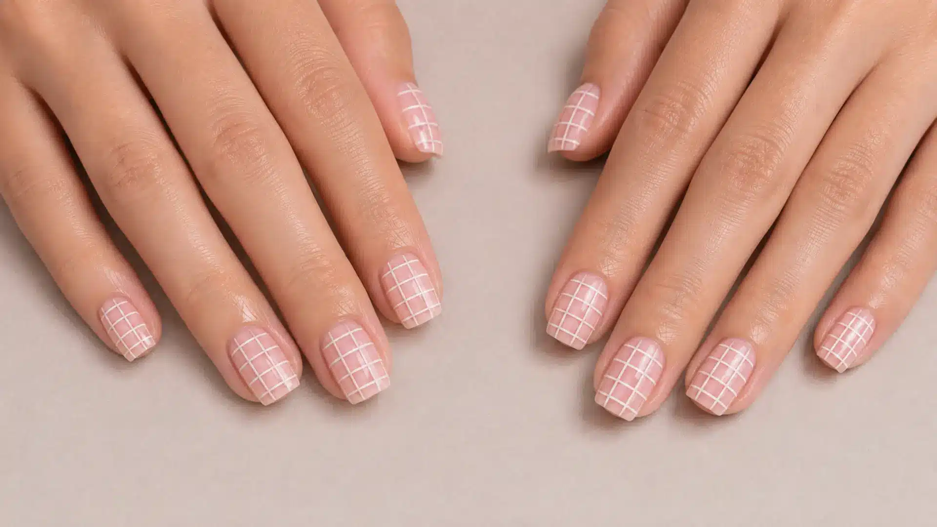 Square nails with a fine white crosshatch grid detail on a milky nude base, textile-inspired